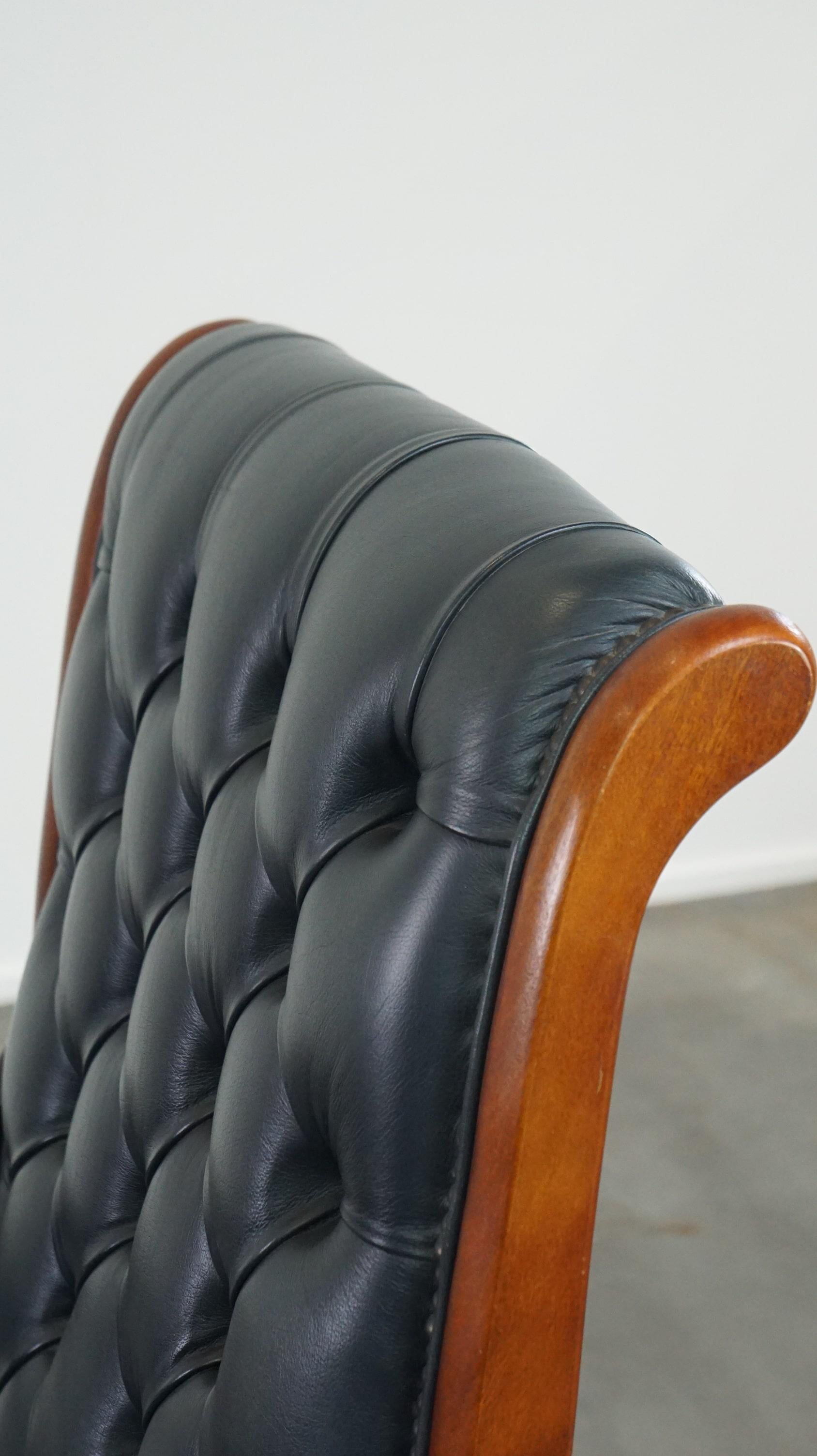 Graceful dark blue chesterfield armchair made of cow leather combined with wood For Sale 3
