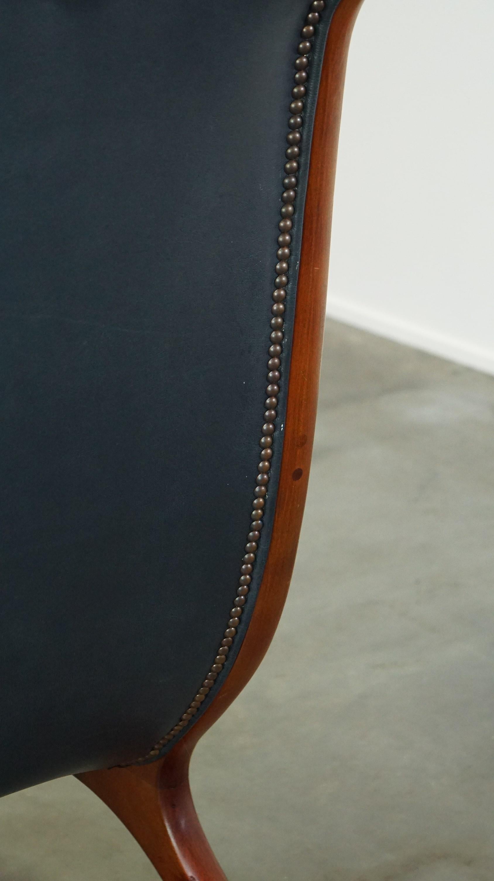 Graceful dark blue chesterfield armchair made of cow leather combined with wood For Sale 4