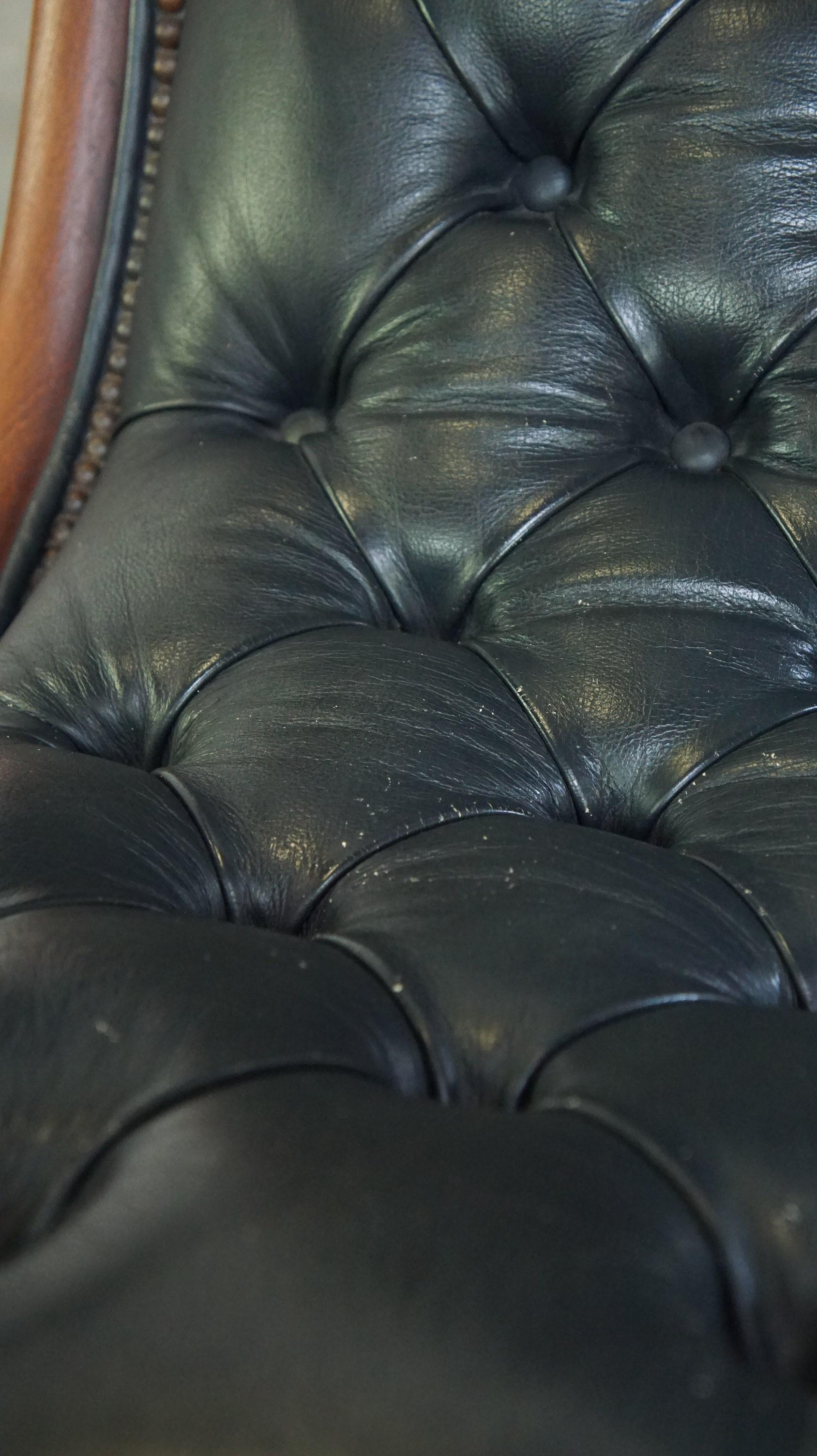 Graceful dark blue chesterfield armchair made of cow leather combined with wood For Sale 5