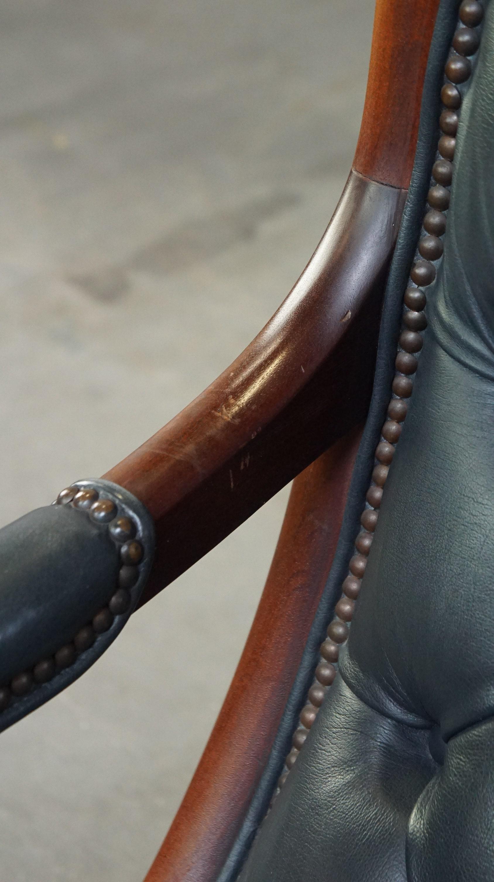 Graceful dark blue chesterfield armchair made of cow leather combined with wood For Sale 6