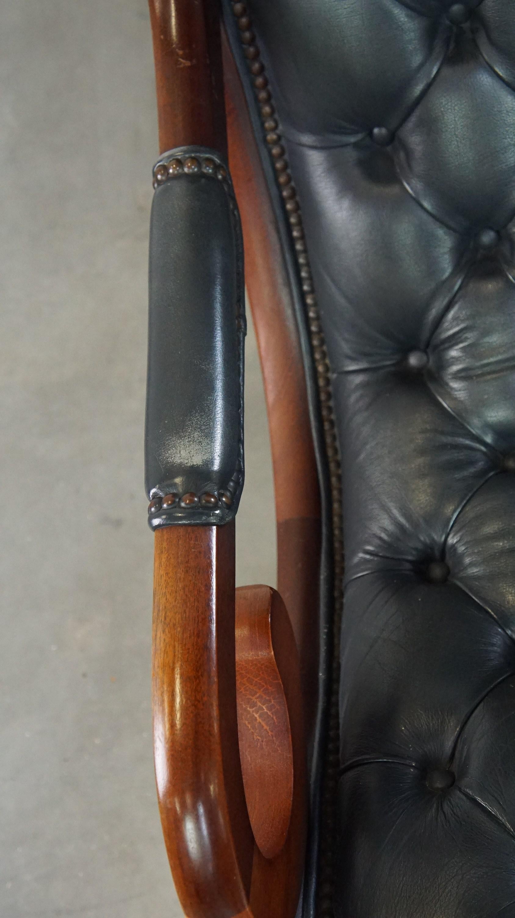 Cowhide Graceful dark blue chesterfield armchair made of cow leather combined with wood For Sale