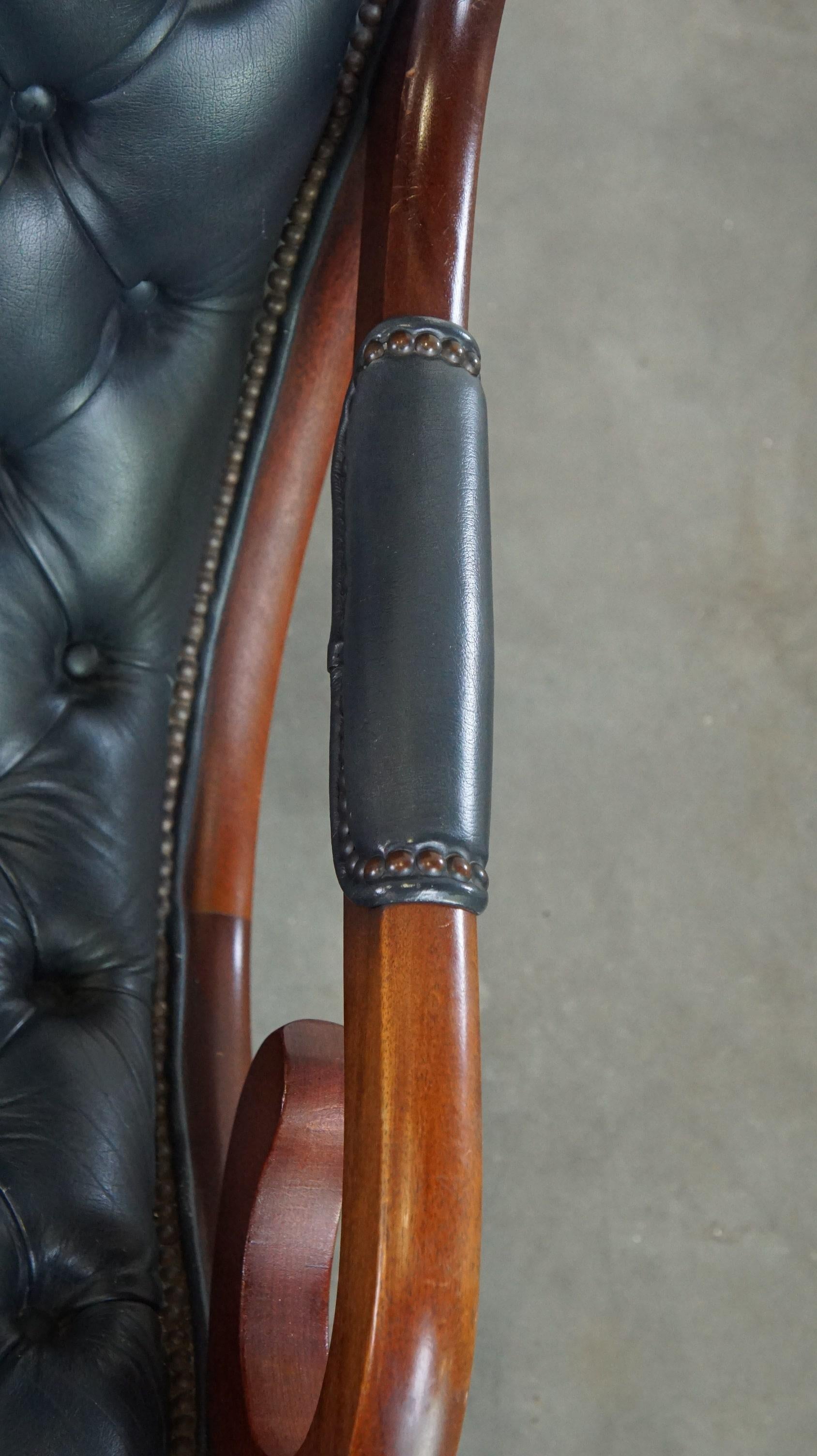 Graceful dark blue chesterfield armchair made of cow leather combined with wood For Sale 1