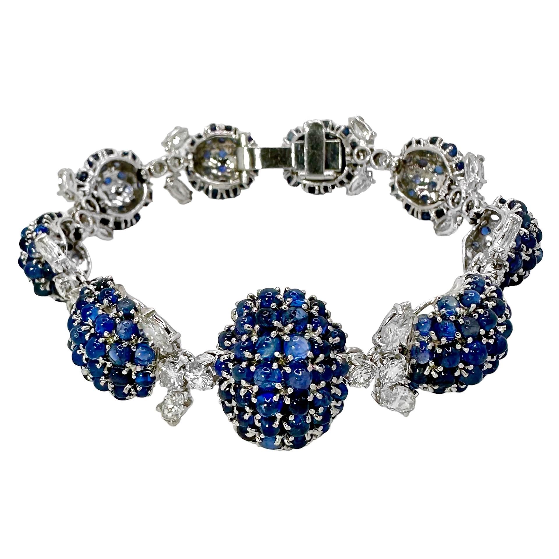 This graceful Mid-20th Century creation is a fine example of the Retro genre and is expertly set with lovely natural blue sapphire cabochons and brilliant cut and marquise diamonds. The bracelet consists of a single line of nine high dome sections,