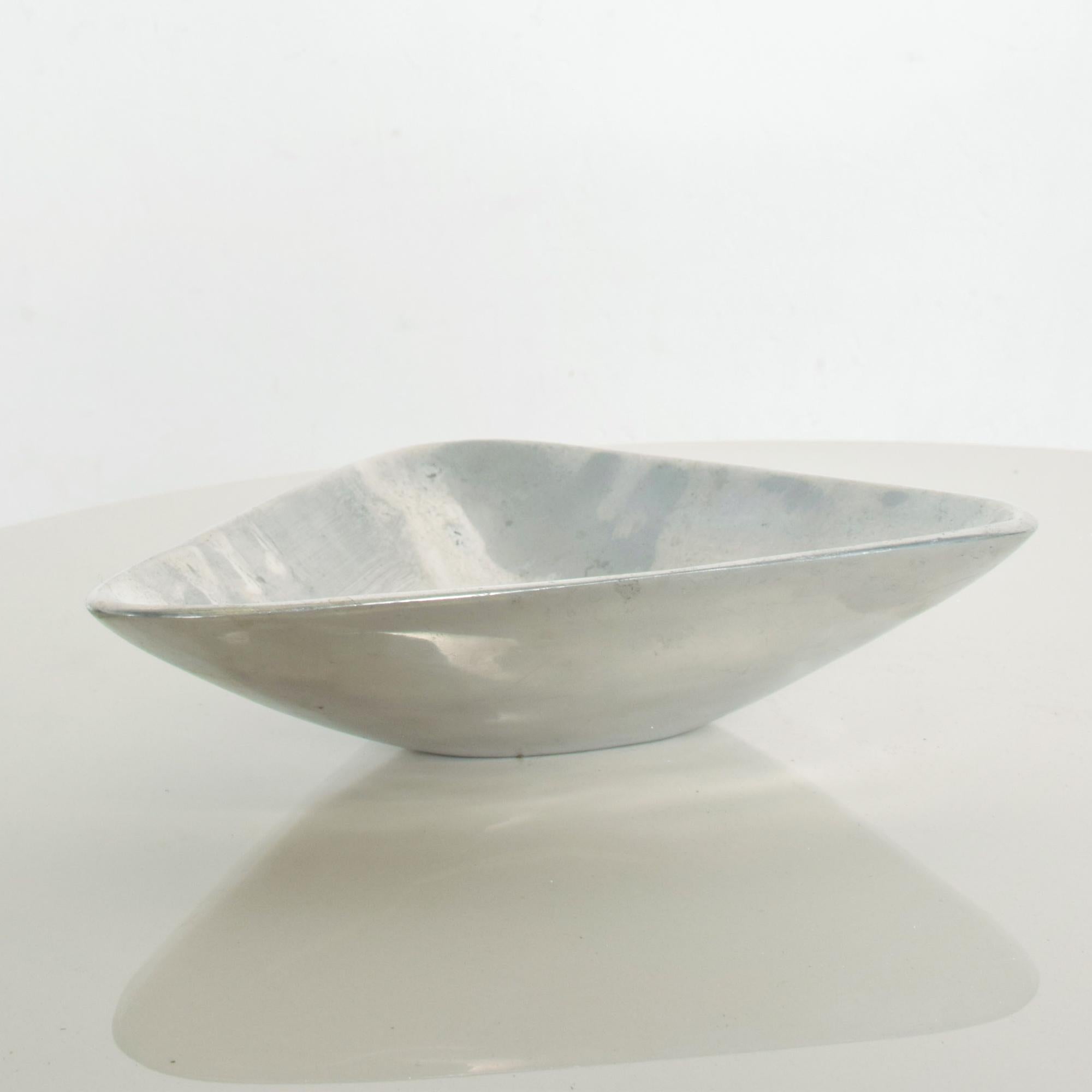 Graceful Midcentury Modern Vintage  Silver Triangular Bowl Decorative Candy Dish Serving Piece Catch-All. circa the 1960s
After Designer for Nambe Richard K. Thomas sculptor. No stamp or label present. 
Measures: 8