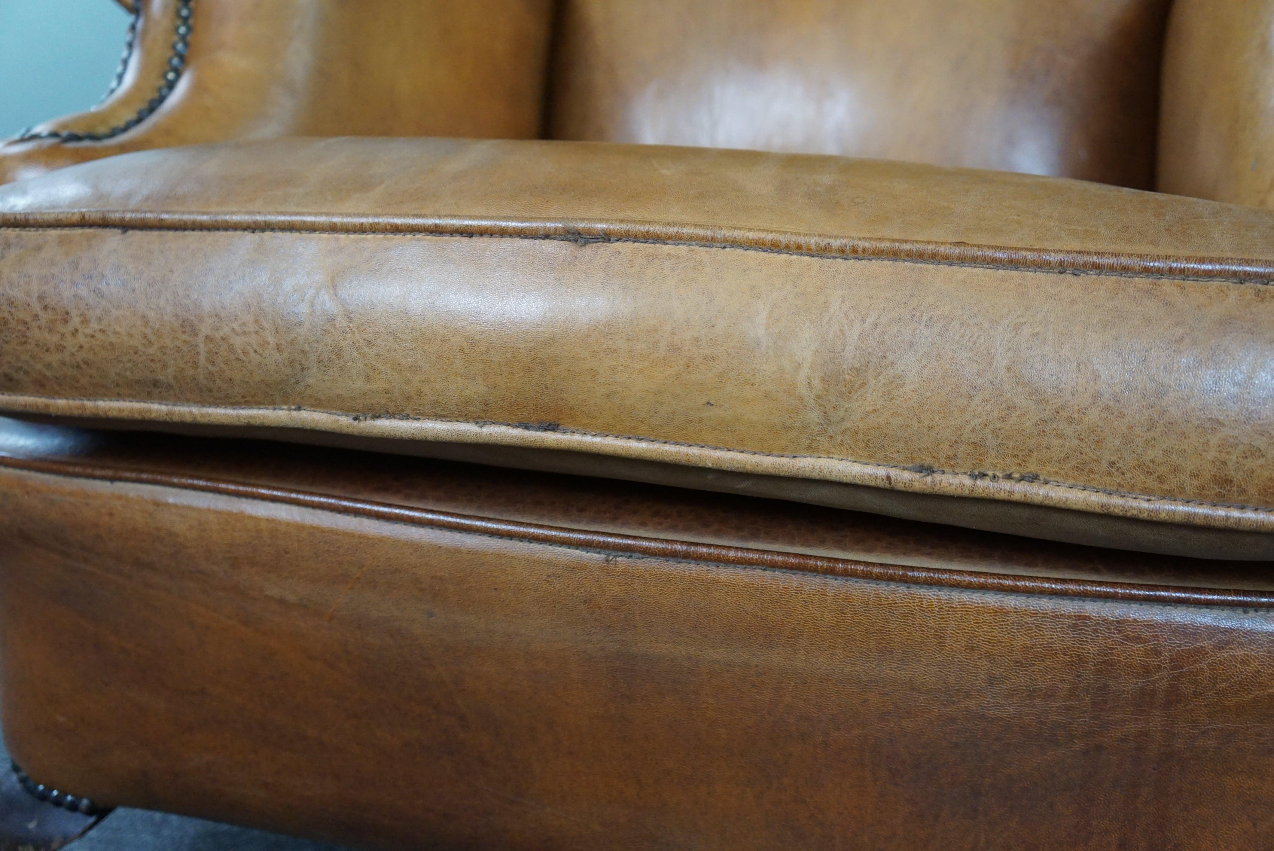 Graceful old wing chair made of sheep leather in correct condition For Sale 7