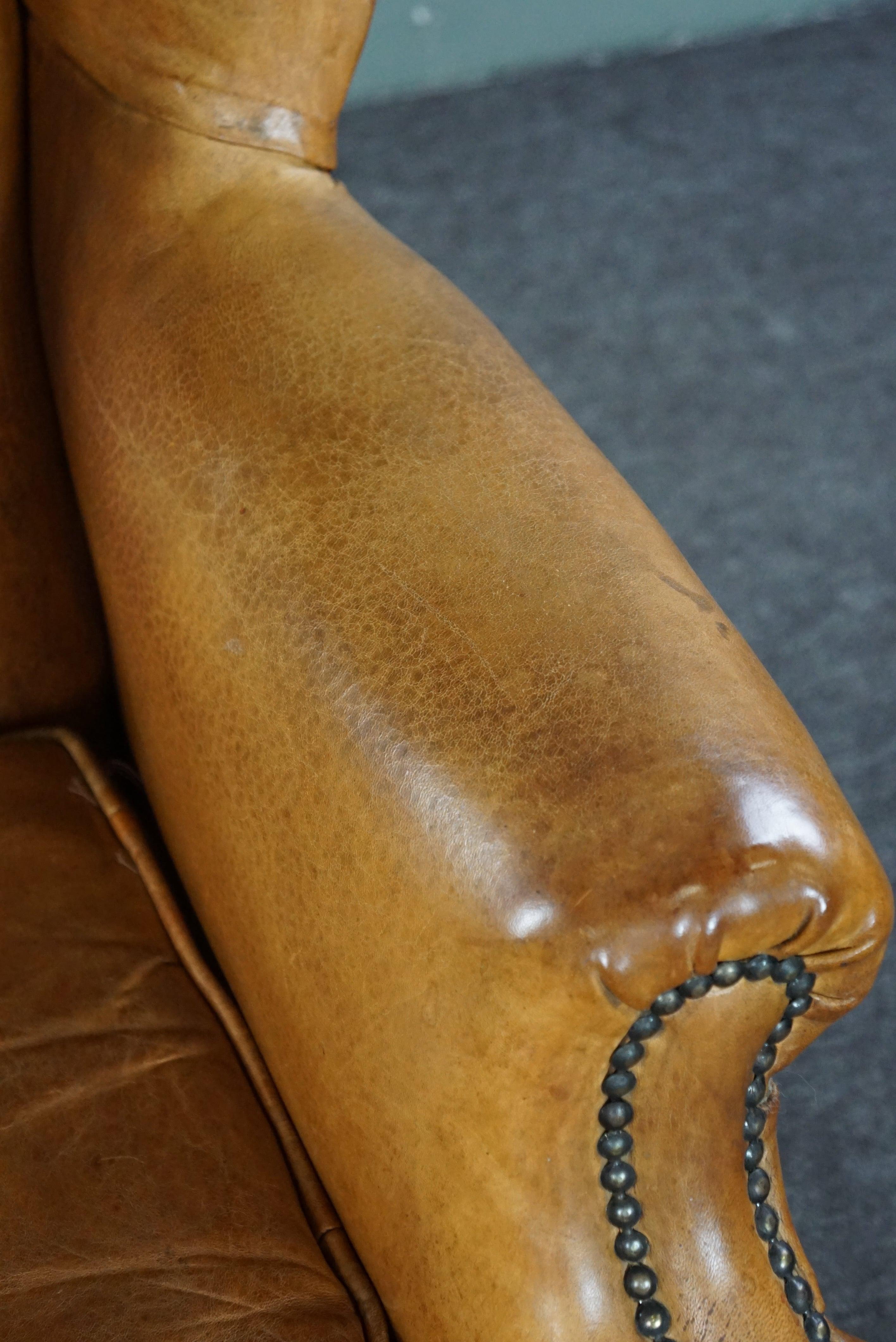 Graceful old wing chair made of sheep leather in correct condition For Sale 2