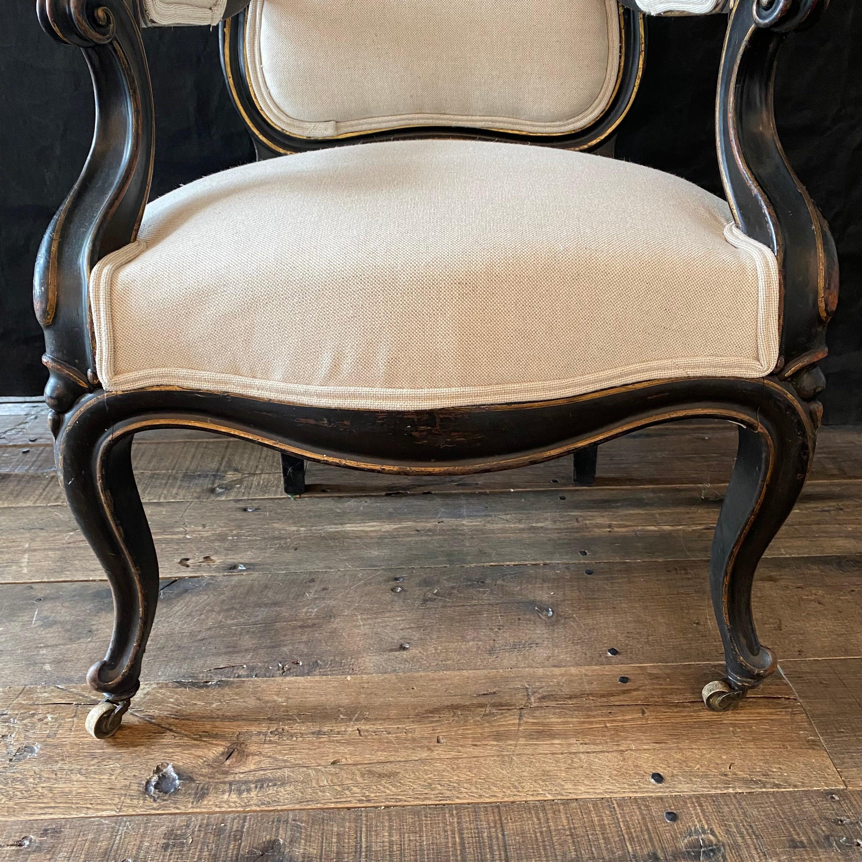Pair of graceful Napoleon III ebonized salon arm chairs with balloon back, cabriole legs, and new upholstery. France, circa 1870. Beautifully restored frames with original ebonized wood. Wonderful as dining chairs or in a living room.
Arm height
