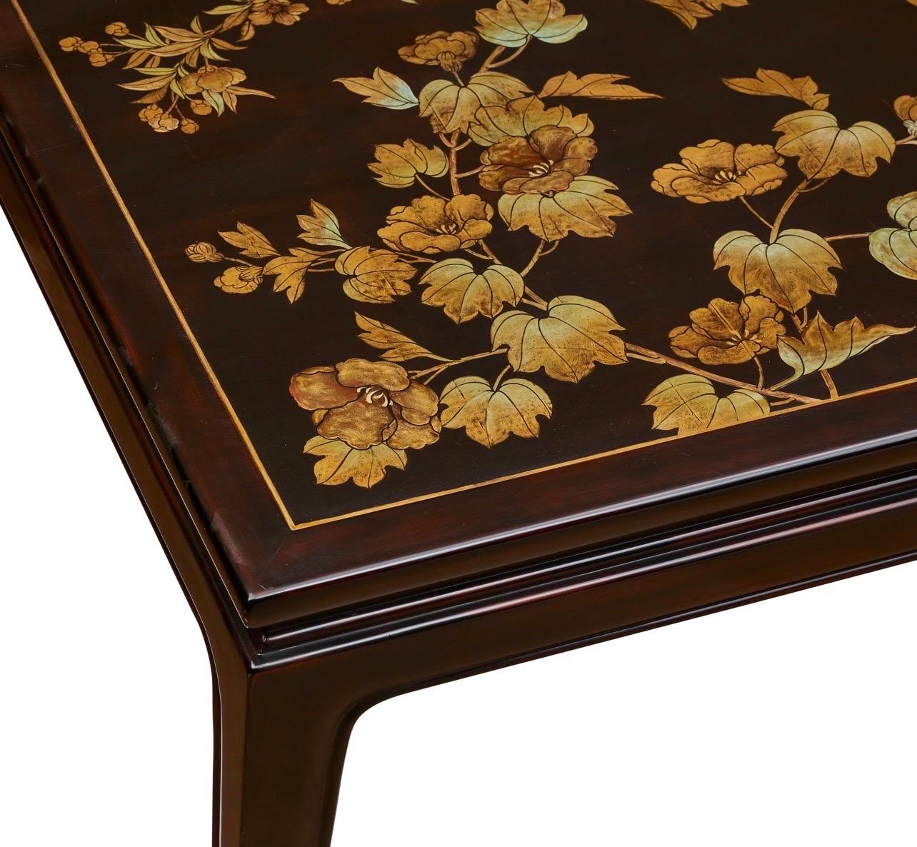 A one of a kind handmade coffee table by Gracie's New York artists, c. 2000.  This wood table has classic lines, with elegantly tapered horsehoof legs.

The top was handpainted with a gilded floral design, slightly raised, and the inset panel of