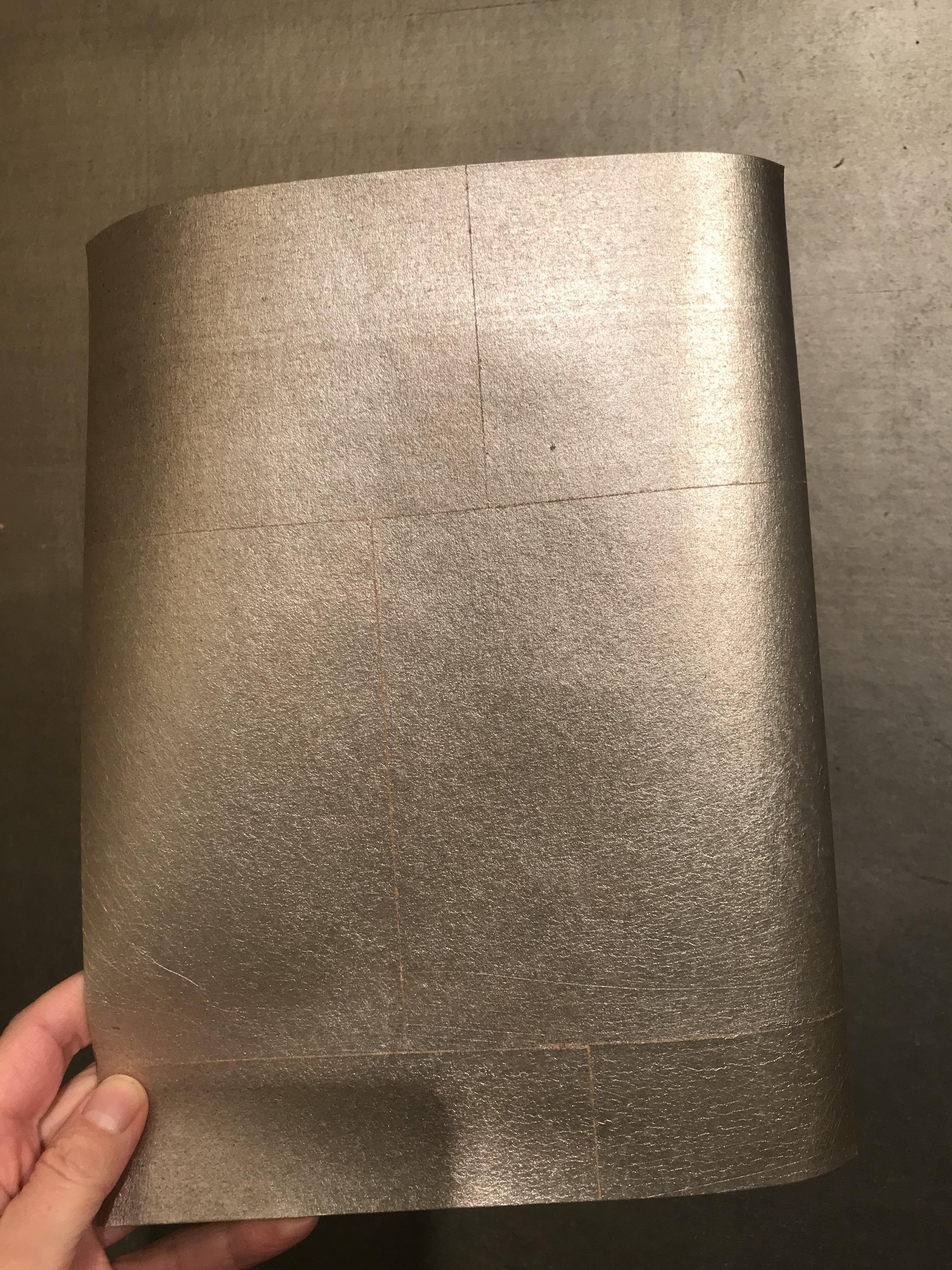 Gracie, established in 1898, makes this shimmering metal leaf paper by hand. The roll size is 3' by 24', and the metal leaf squares are slightly overlapped in a random pattern and measure about 5.5
