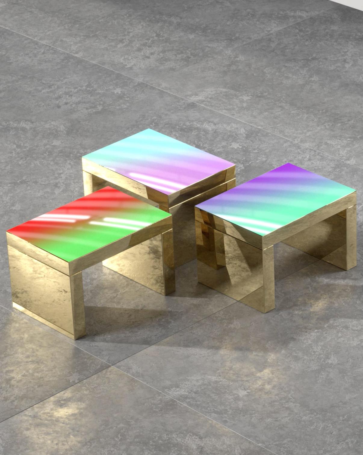 Gaby is a contemporary coffee table that presents shades of color integrated in the table top, which is paired with a chunky and highly reflective gold metallic base. 
The multicolored shades mix to create new combinations of colors on the top from