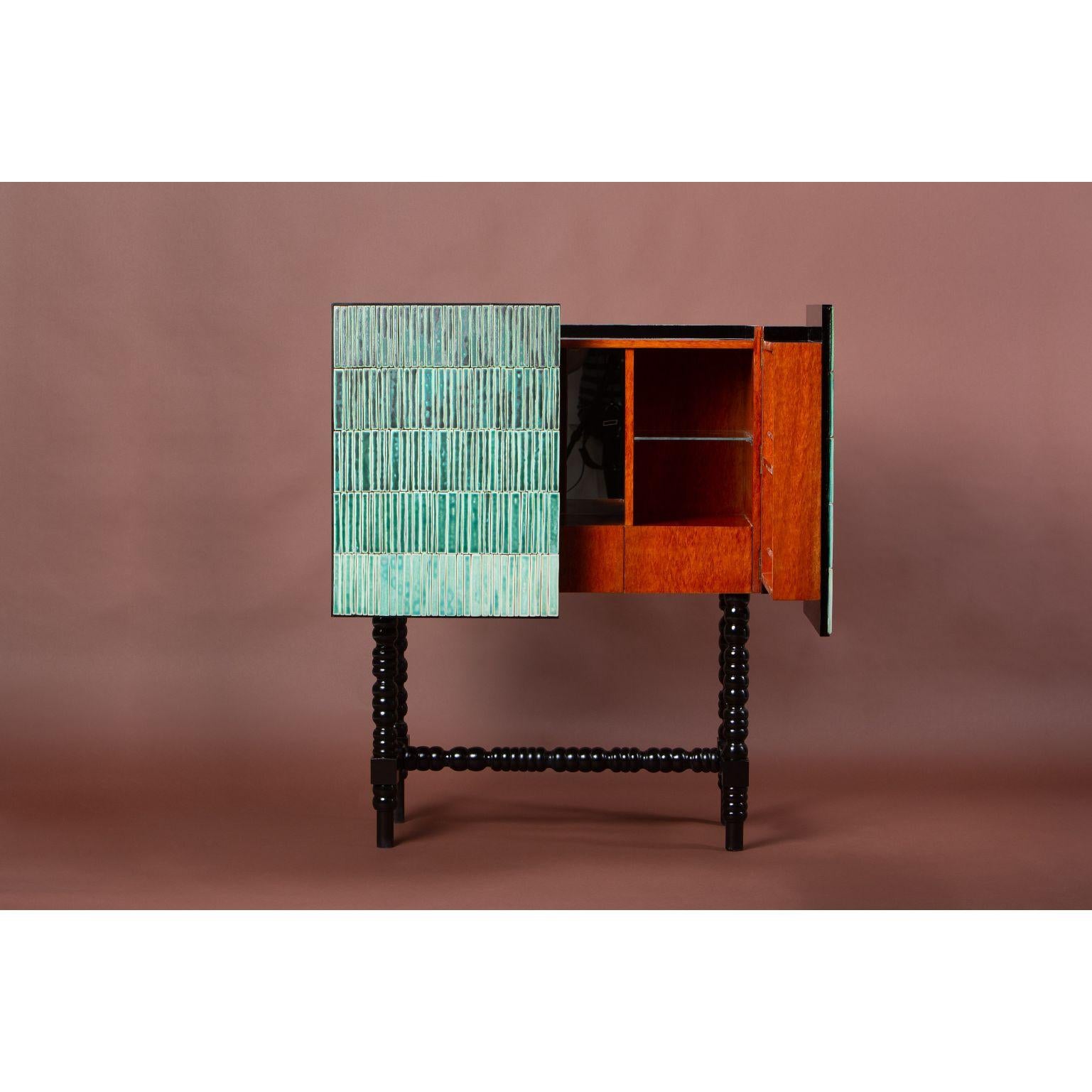 Gradient cabinet - green by Milan Pekar, Jakub Vávra
Dimensions: 102 x 55 x 125 cm
Materials: Glaze, ceramic, beech wood

Hand-crafted in the Czech Republic

Gradient is an original furniture collection combining exotic wood and ceramic