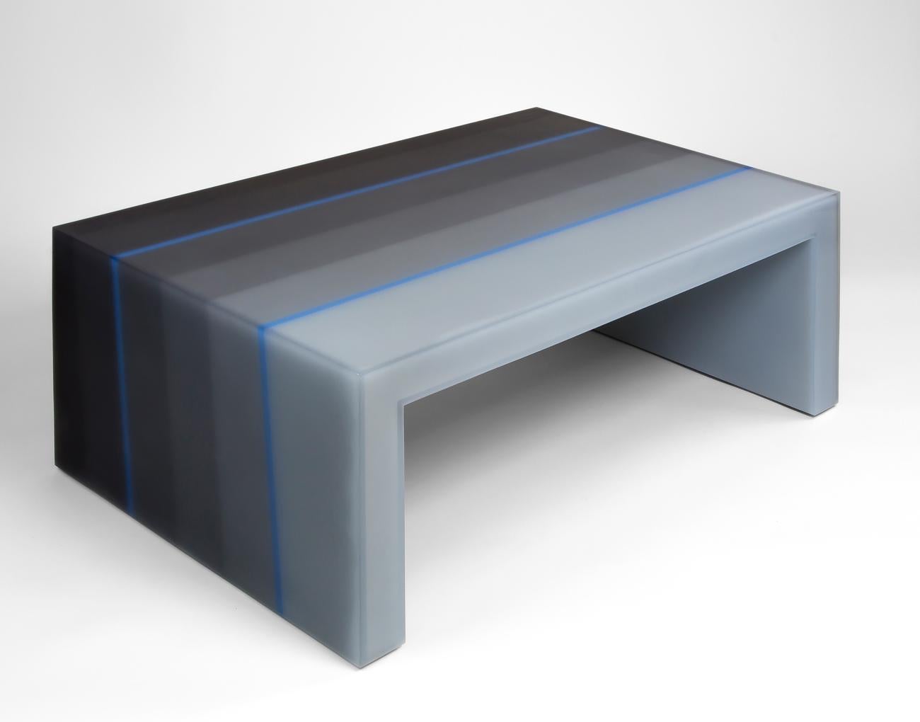 This resin coffee table, infused with soothing shades of grey, is meticulously crafted in six parallel sections by furniture designer Facture Studio. The color makes a gradual ascent from a gradient light to dark from one layer to the next, creating