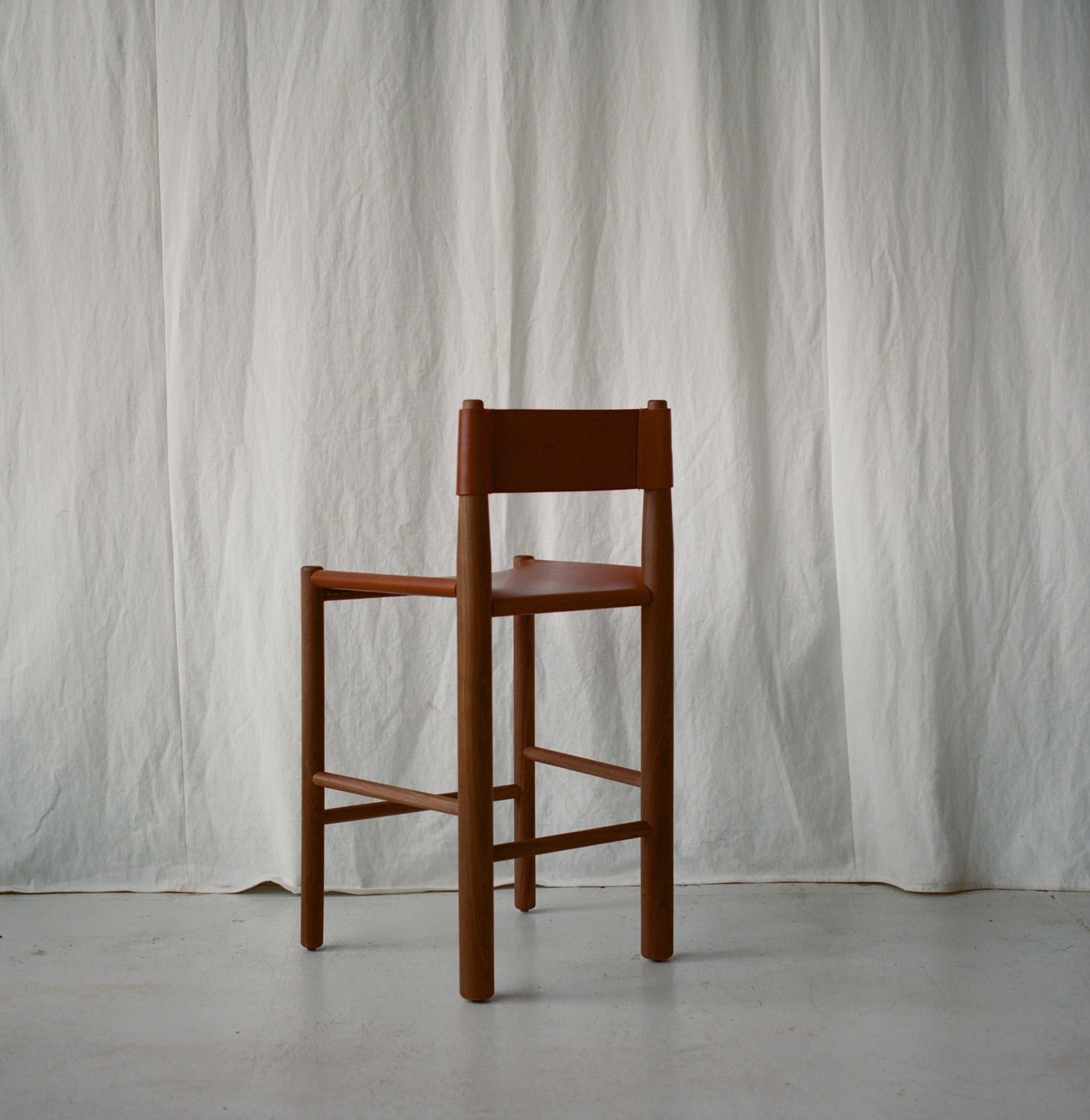 Inspired by utilitarian furniture, the Gradual Counter Stool plays with the proportions of different size turned wood parts. The front and back legs are different diameters, and the back tapers, declining gradually to allow for a slung leather back.