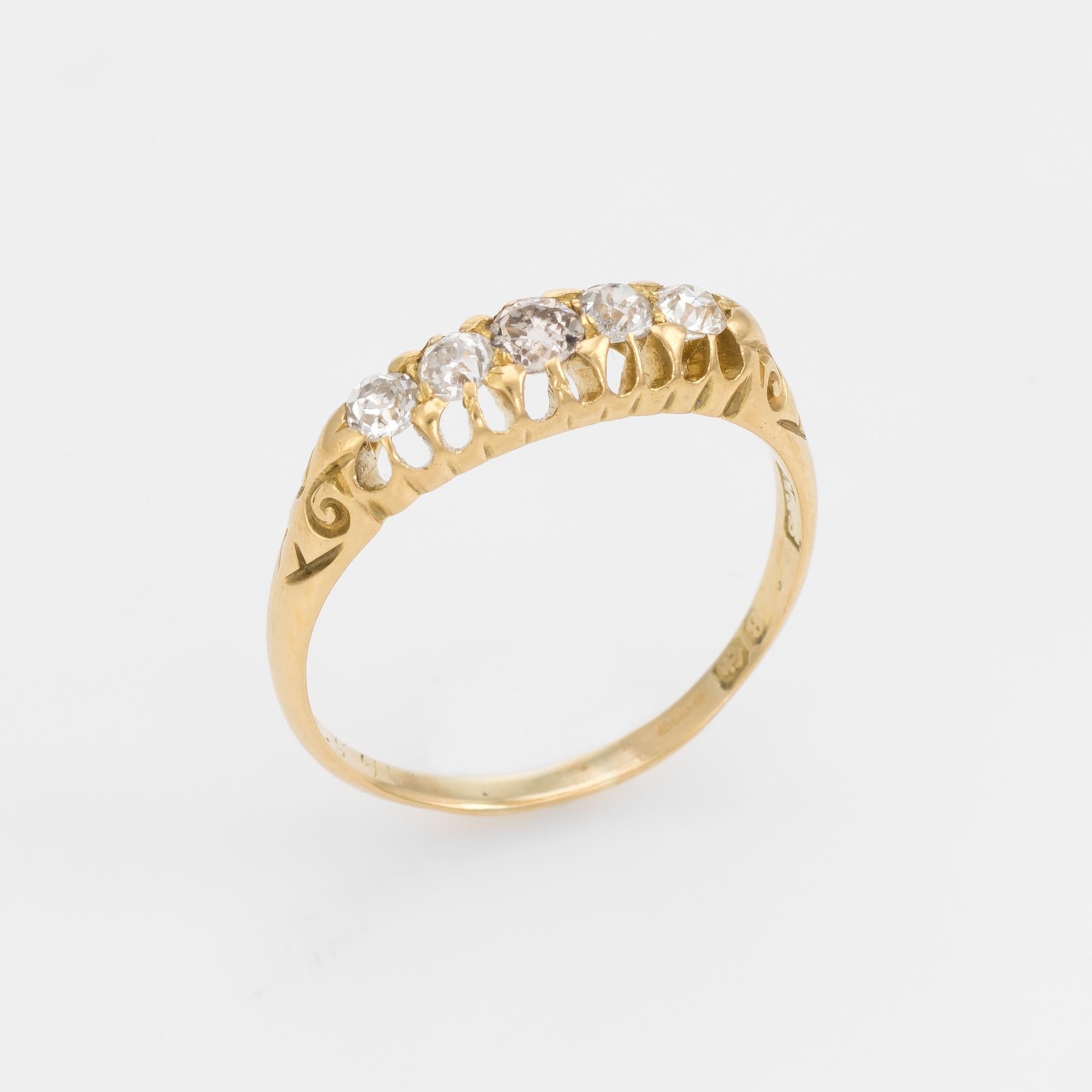 Finely detailed antique Edwardian era ring set with 5 graduated old mine cut diamonds (circa 1907), crafted in 18 karat yellow gold. 

The old mine cut diamonds graduate in size from the center (estimated at 0.20 carats) to the sides graduating from