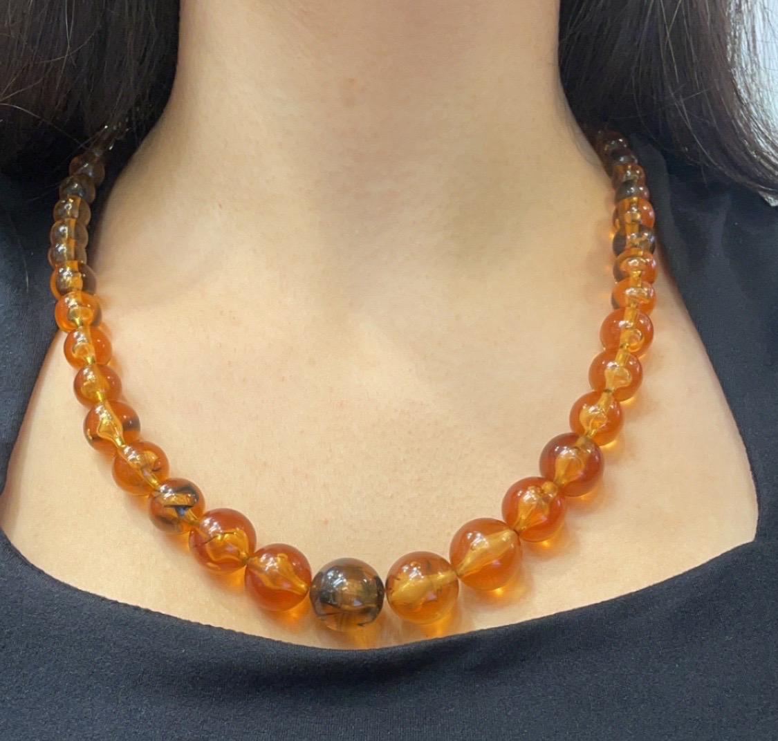 Graduated Amber Bead Necklace 

A beaded necklace featuring graduated amber beads with the largest bead measuring approximately 18mm, and the smallest approximately 7.5mm.

Approximate Length: 24