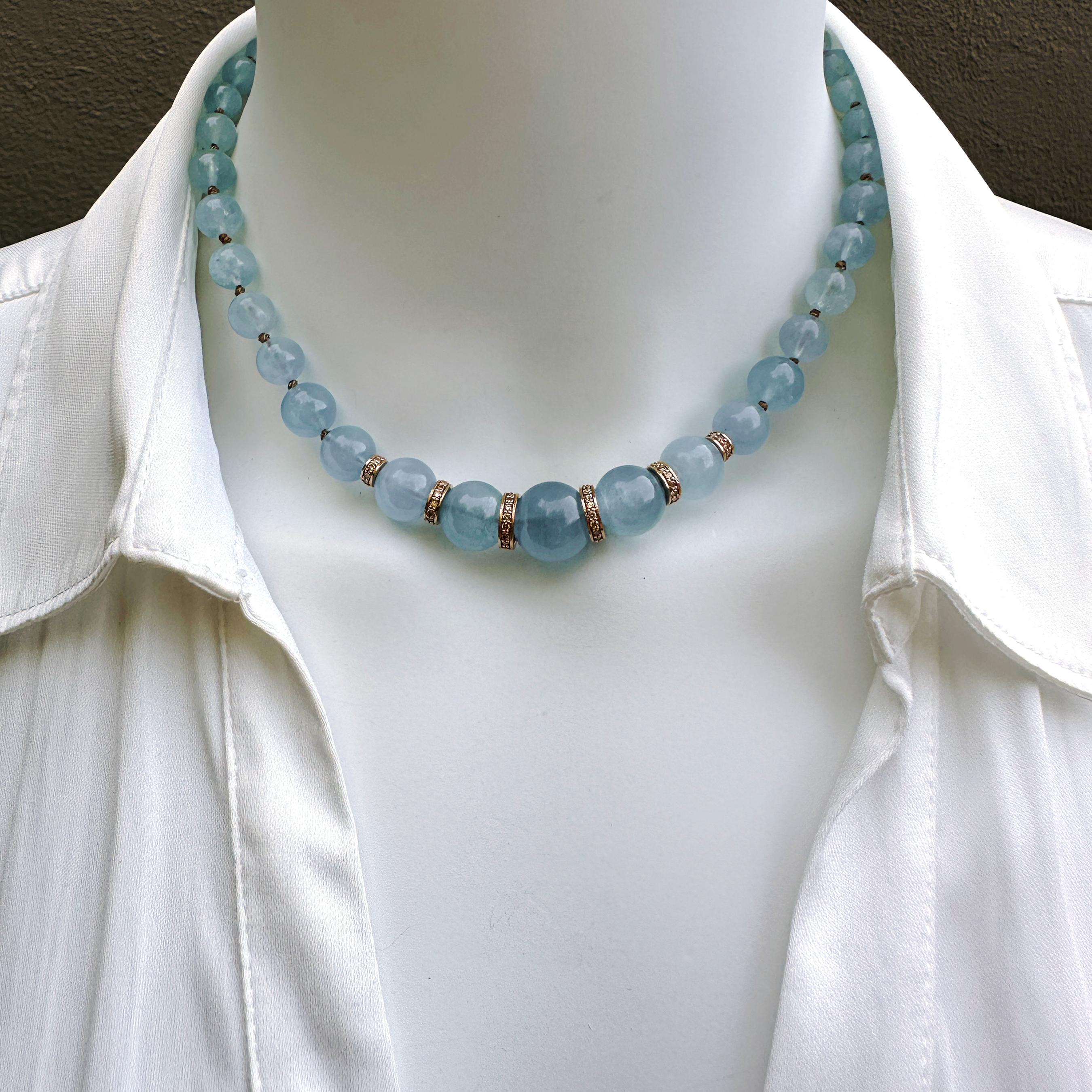 Strung on copper-colored silk and knotted like a string of pearls, these graduated round milky-soft aquamarine beads would  be beautiful enough on their own, but we've given them an extra dose of glam by adding six diamond rondelle beads.  

The