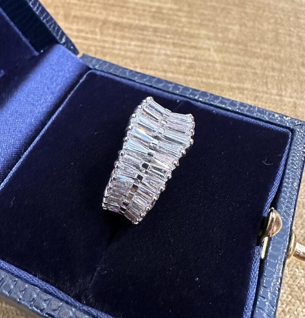 Graduated Baguette Diamond Eternity Ring in Platinum 

Baguette Diamond Band features two Rows of Graduating Baguette Diamonds set side by side in Platinum with 64 Diamonds in total.

Total diamond weight is estimated to be 2.50 carats.

Ring size