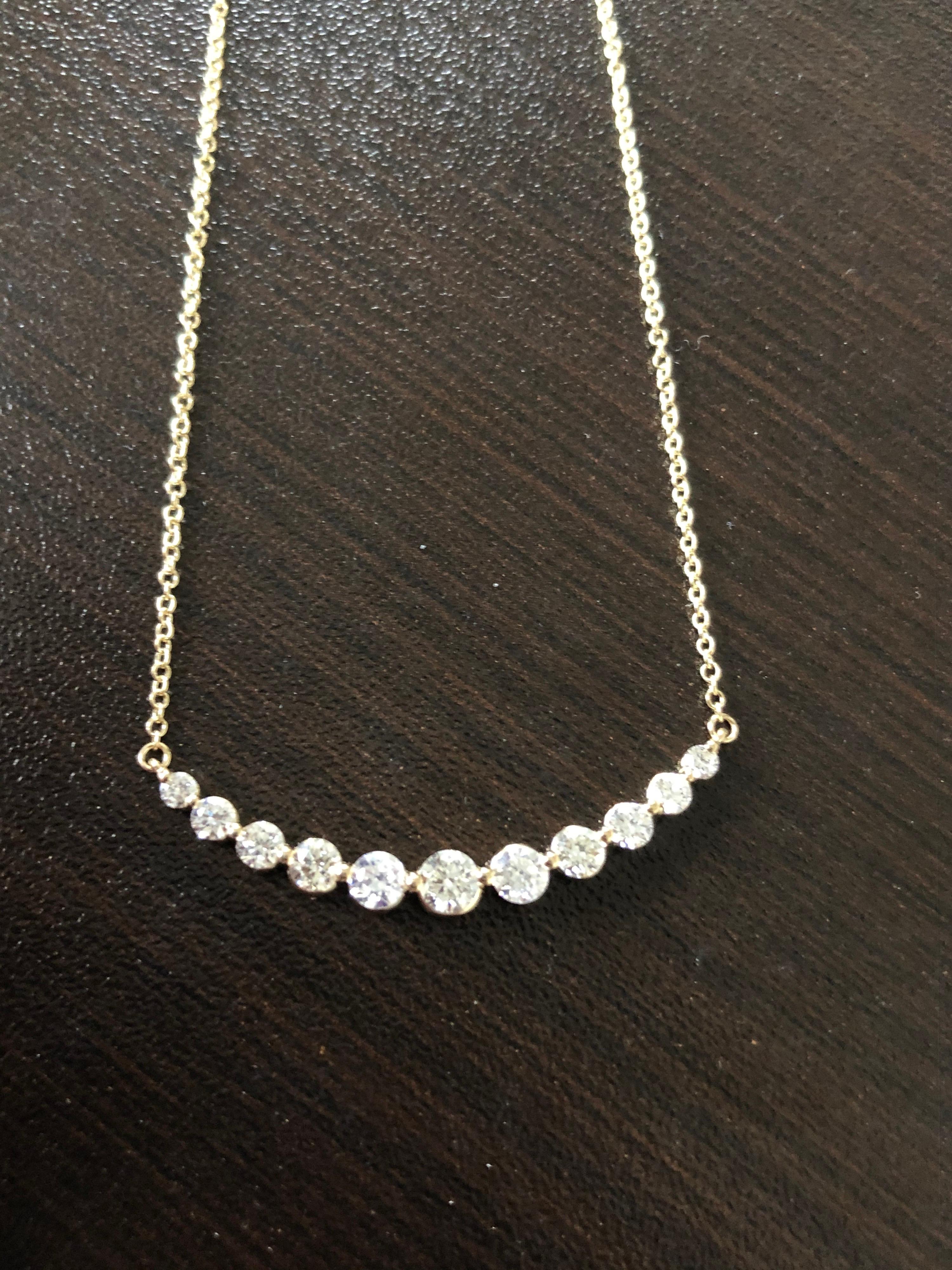Diamond bar pendant set in 14K yellow gold. The total carat weight of this pendant is 1.35. The center stone weighs 0.25 carats. The clarity of the stones are SI, the color is G-H. This pendant is available in white gold. 