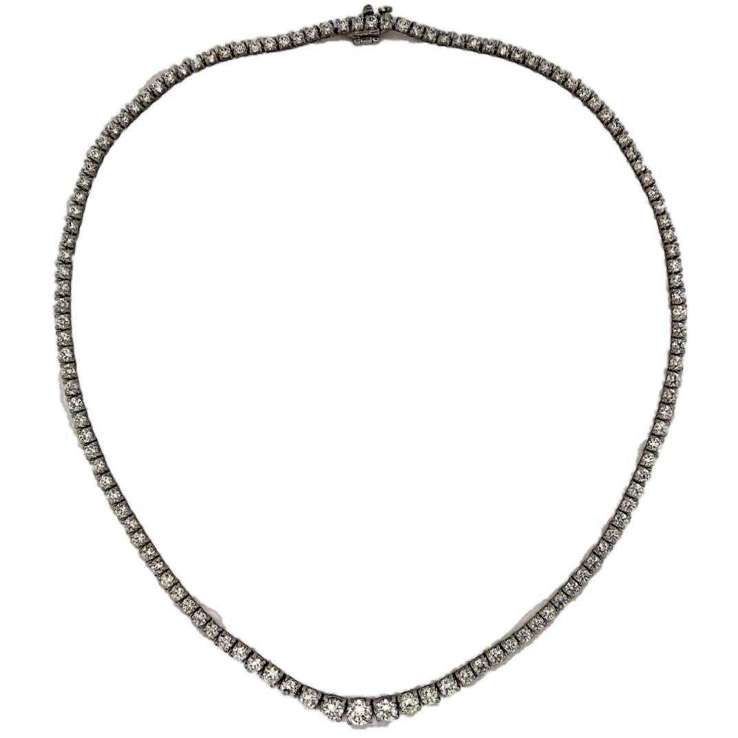 This classic graduated diamond Riviera necklace is set with 123 round brilliant cut diamonds in four prong platinum heads. The total approximate weight is 9.78CTS of overall G/H Color and VS1-VS2 Clarity. Total length is 16 inches long. Gross weight