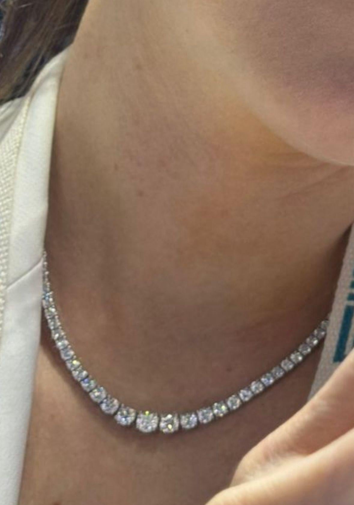 A true statement of refined luxury, this graduated Riviera-style diamond tennis necklace is masterfully handcrafted in 18K white gold and adorned with 9 carats of natural round brilliant diamonds. Designed with a seamless flow of brilliance, the