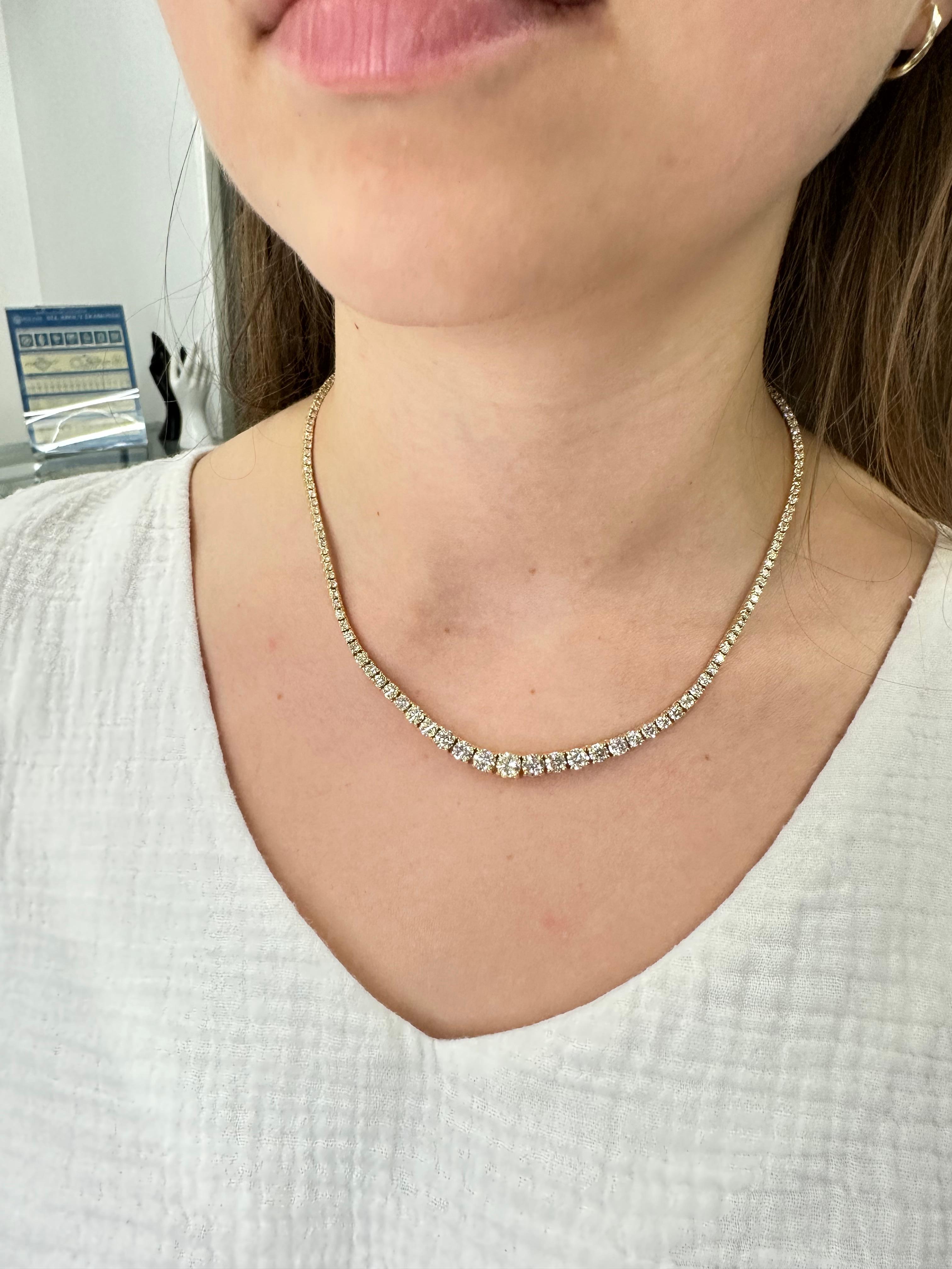 Introducing the stunning 7.27 Carat Graduated Diamond Tennis Necklace, set in luxurious 14K Yellow Gold with a classic 4-prong setting. This exquisite piece features a range of sparkling diamonds, each carefully selected and expertly crafted to