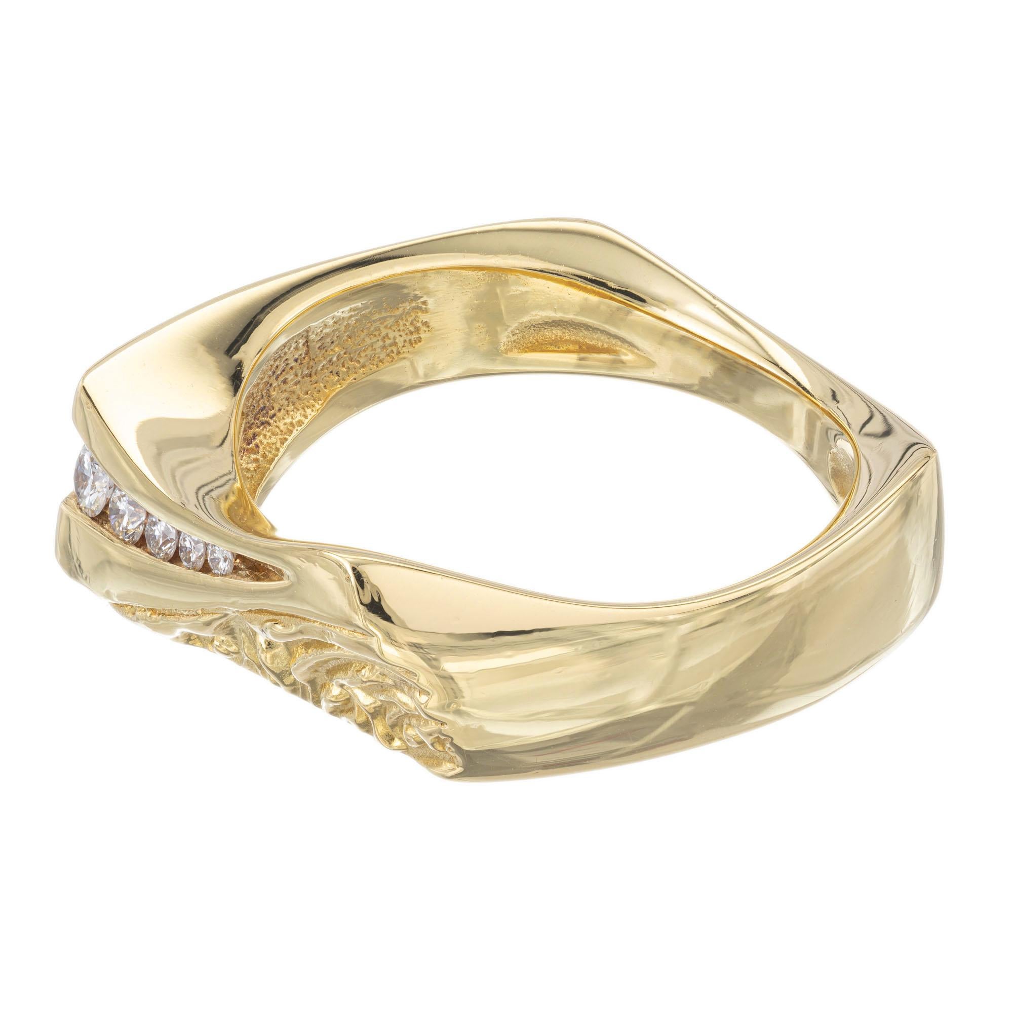 .18 carat graduated round diamond ring. 10 round graduated diamonds in an 18k yellow gold hand engraved band setting.  

10 round diamonds, G VS approx. .18cts
Size 7 and sizable
18k yellow gold 
8.9 grams  
11/16 x 5/16 inches.  
 
