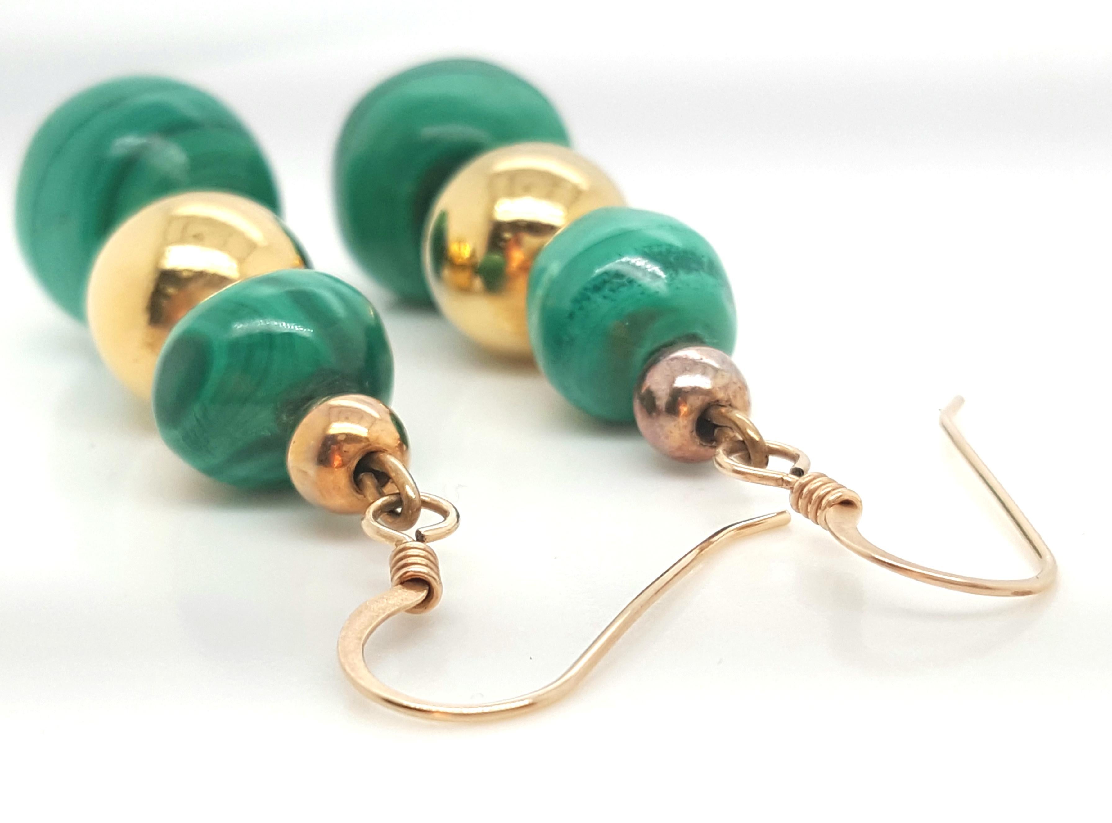 Graduated Malachite Bead Earrings Accented by Gold Plated Beads are mesmerizing.  The earrings are each composed of  two malachite beads alternating with gold plated beads for a perfect accent and is finished with a sheperd's hook.  The earrings are