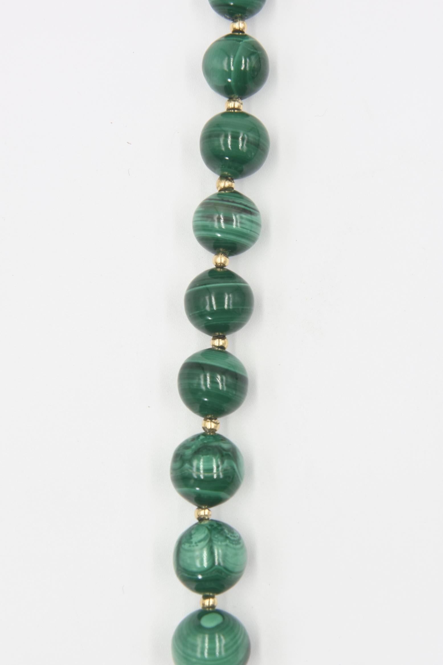 Graduated strand of 15.9 mm to 8.6 mm malachite beads interspersed with small 2.8 mm gold-plated beads terminating in a gold-plated filigree sterling silver clasp
