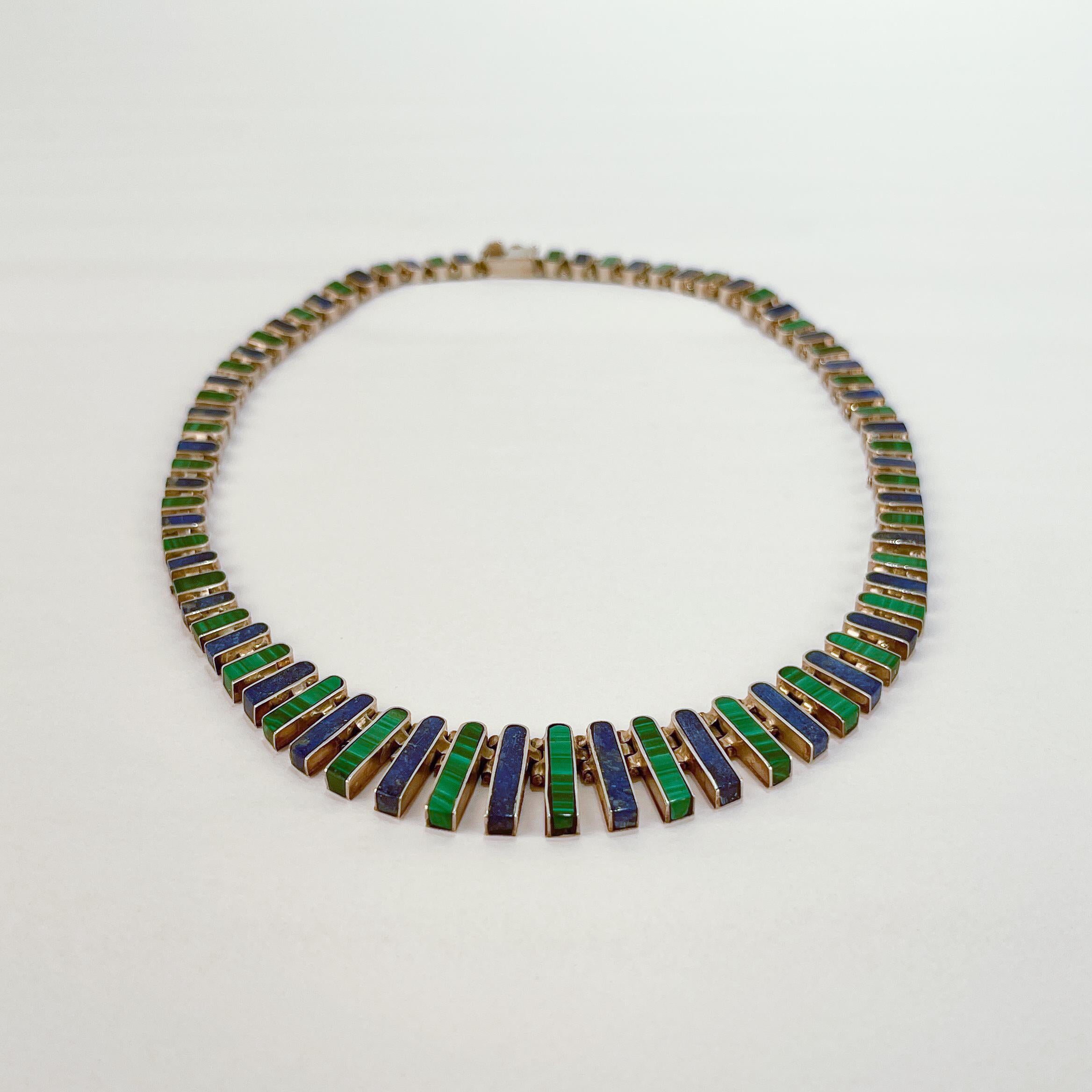 A very fine Mexican sterling silver, malachite, & lapis lazuli graduated opera length necklace.

With graduated sterling silver links set with alternating lapis lazuli and malachite arch-shaped stones.

Simply a wonderful necklace!

Date:
20th
