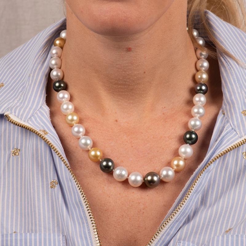 This beautiful necklace features graduated multicolor South Sea Pearls that are finished with a 14 karat yellow gold 10mm pearl ball clasp. The pearls measure between 10-13mm. Natural spotting.
Measurements: Length 18