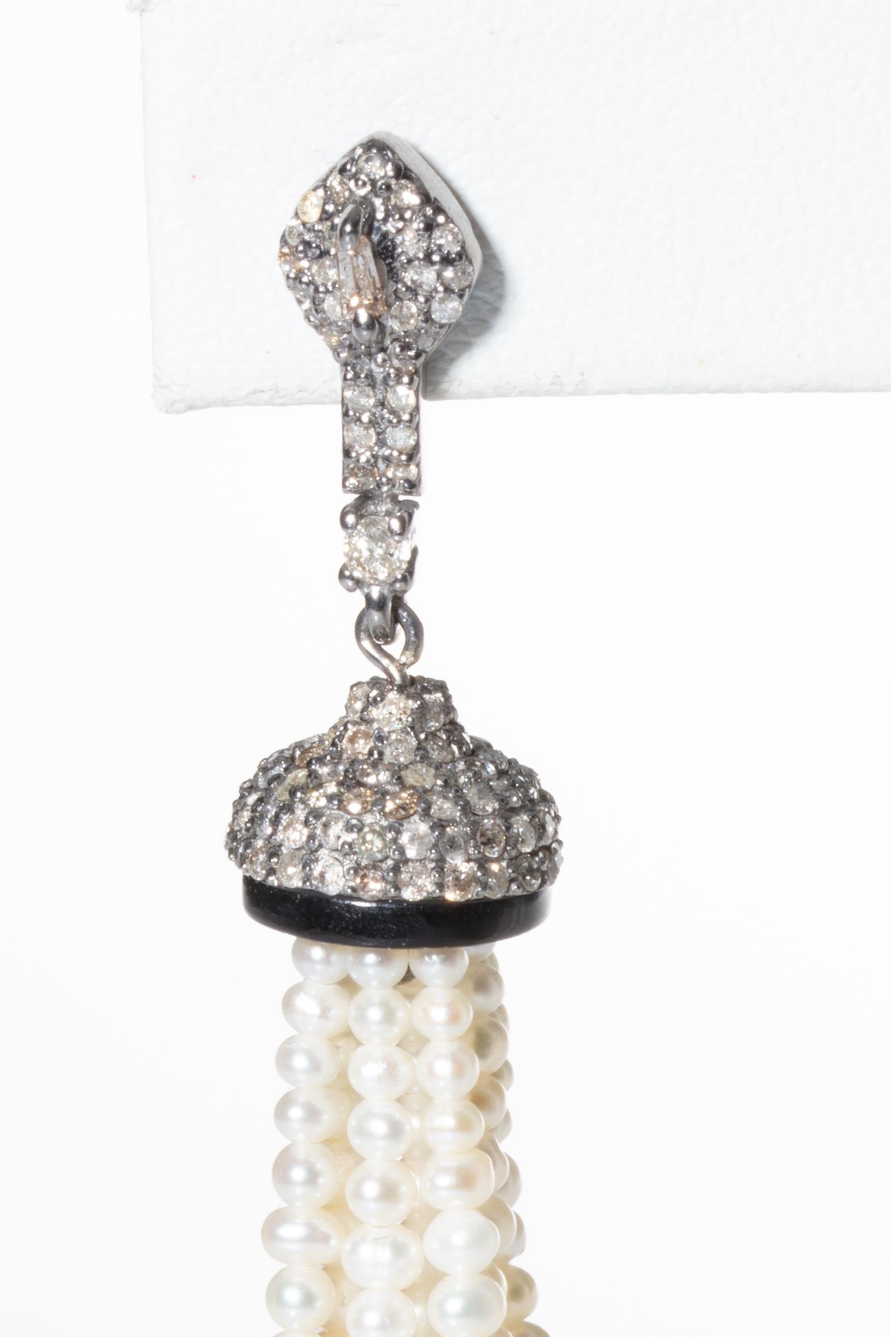 Lovely graduated cultured pearl tassel earrings with a pave` diamond and black onyx end cap.  Post is also pave` diamonds with a diamond baguette at the center.  18K Gold.  Diamonds are 2.61 carats, black onyx is 2.60 carats and the pearls are a