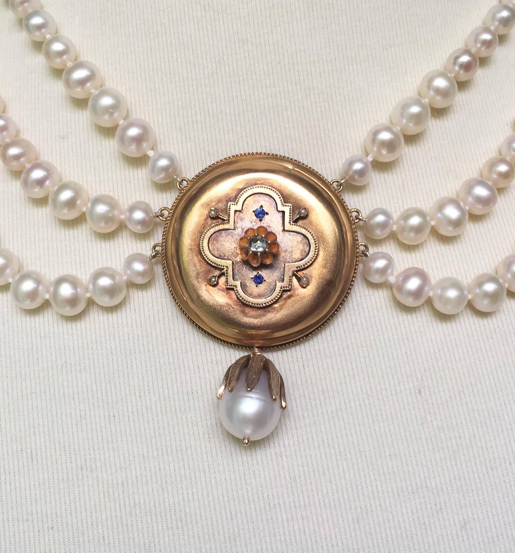 This dramatic pearl necklace is centered around a vintage 14 k yellow gold centerpiece with sapphires and a rough cut diamond. The diamond and sapphires are intricately placed into a beautiful geometric pattern that follows through to the rest of