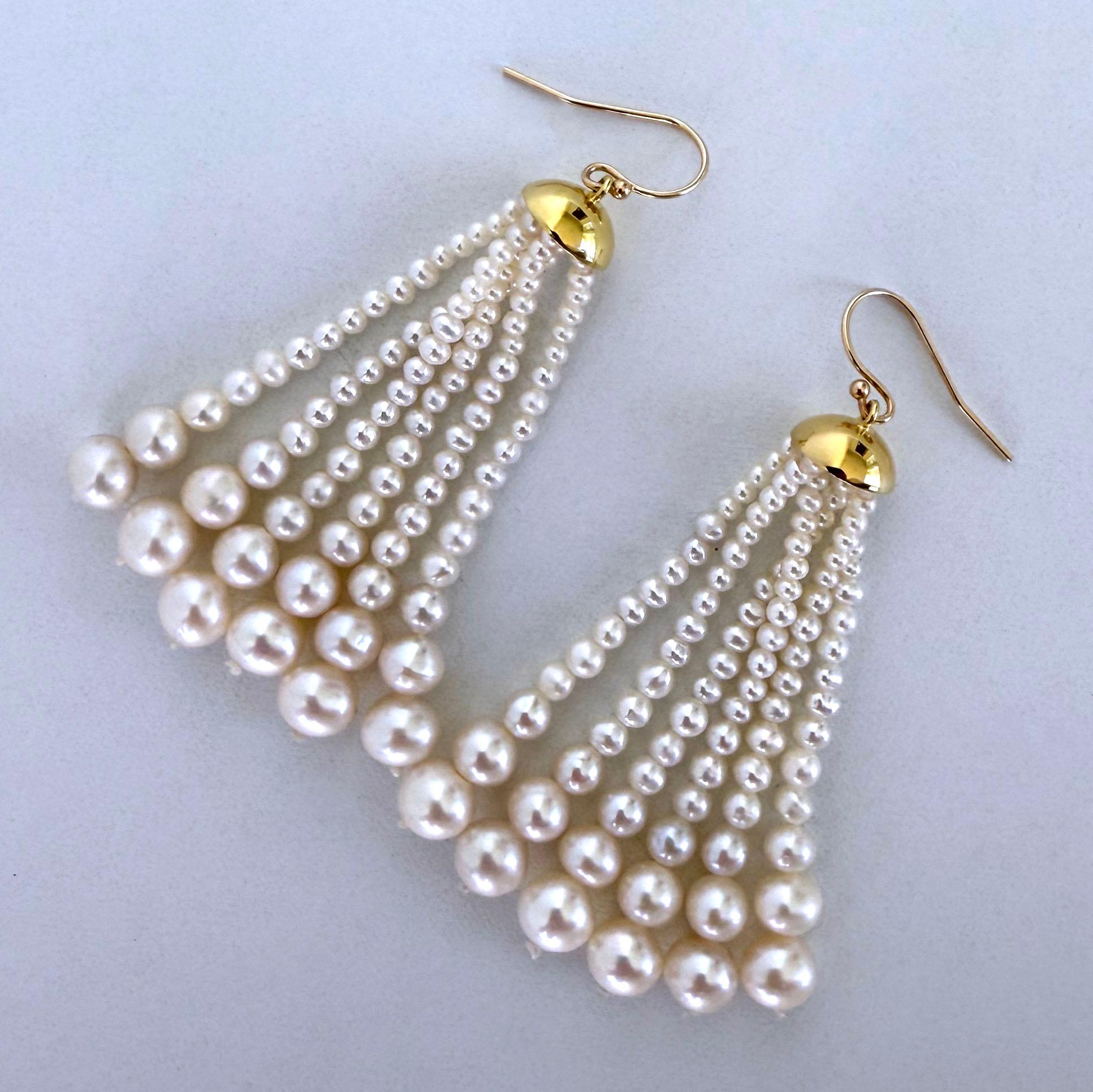 Simple yet beautiful pair of Earrings by Marina J.

This pair features 18k Gold Plated Cups from which multiple strands of Graduate Pearls hang. Measuring 2.5 inches long, this pair hangs off Solid 14k Yellow Gold Hooks that perfectly match the