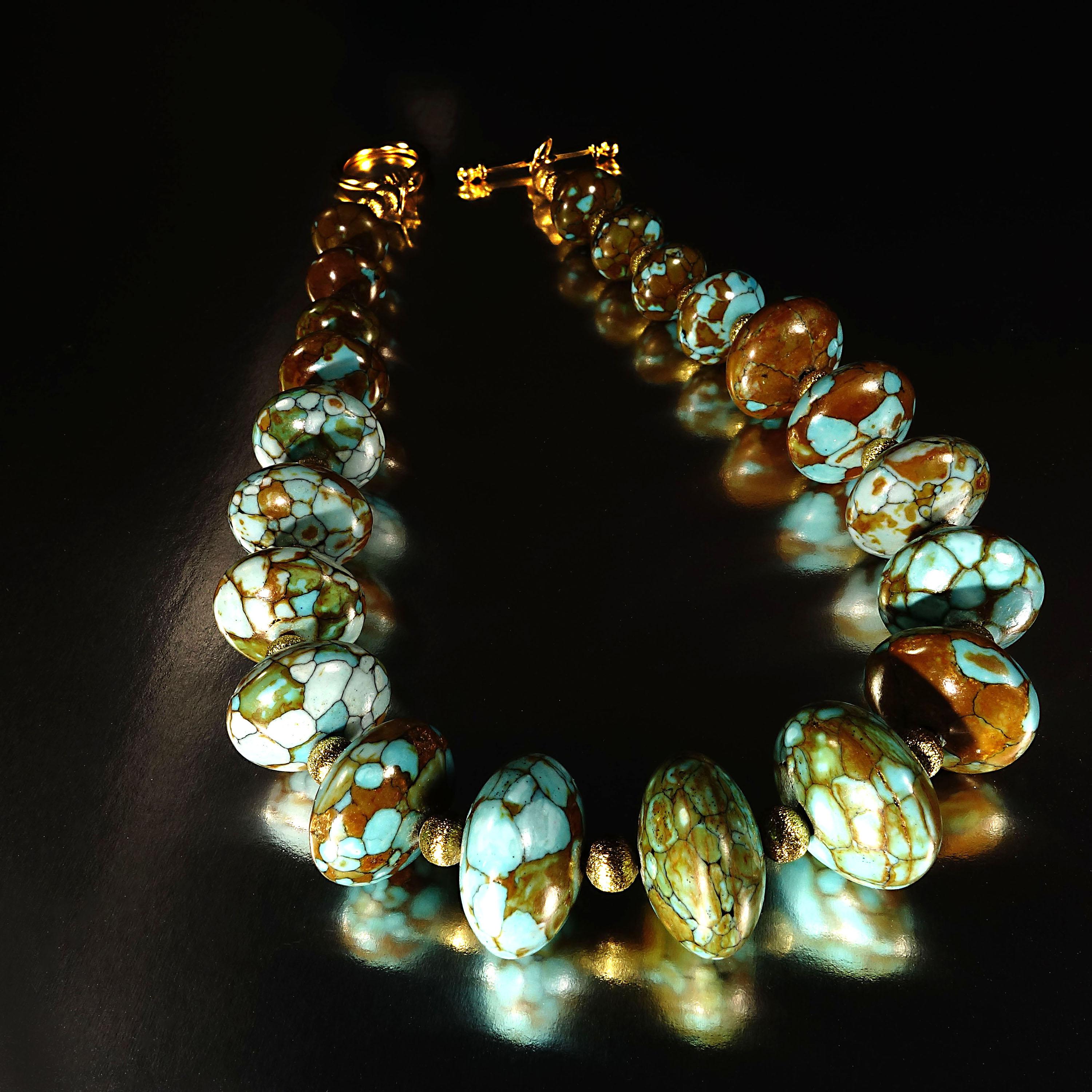Fabulous Fashion necklace of Chinese composite Rondelles of Turquoise in mottled shades of greens and browns. The frosted antique gold tone spacers set off the Turquoise. The necklace is choker length at 14 inches and has a gold tone toggle clasp.
