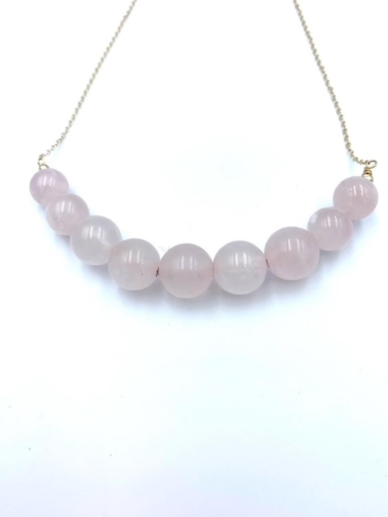 Hand made using 14 carat Yellow Gold, the suspended Rose Quartz Balls are threaded together with a solid gold wire and graduated onto a delicate cable chain. The lovely pink centre bead is 12 mm, 10mm the two following, 8mm the next, 6 mm the last