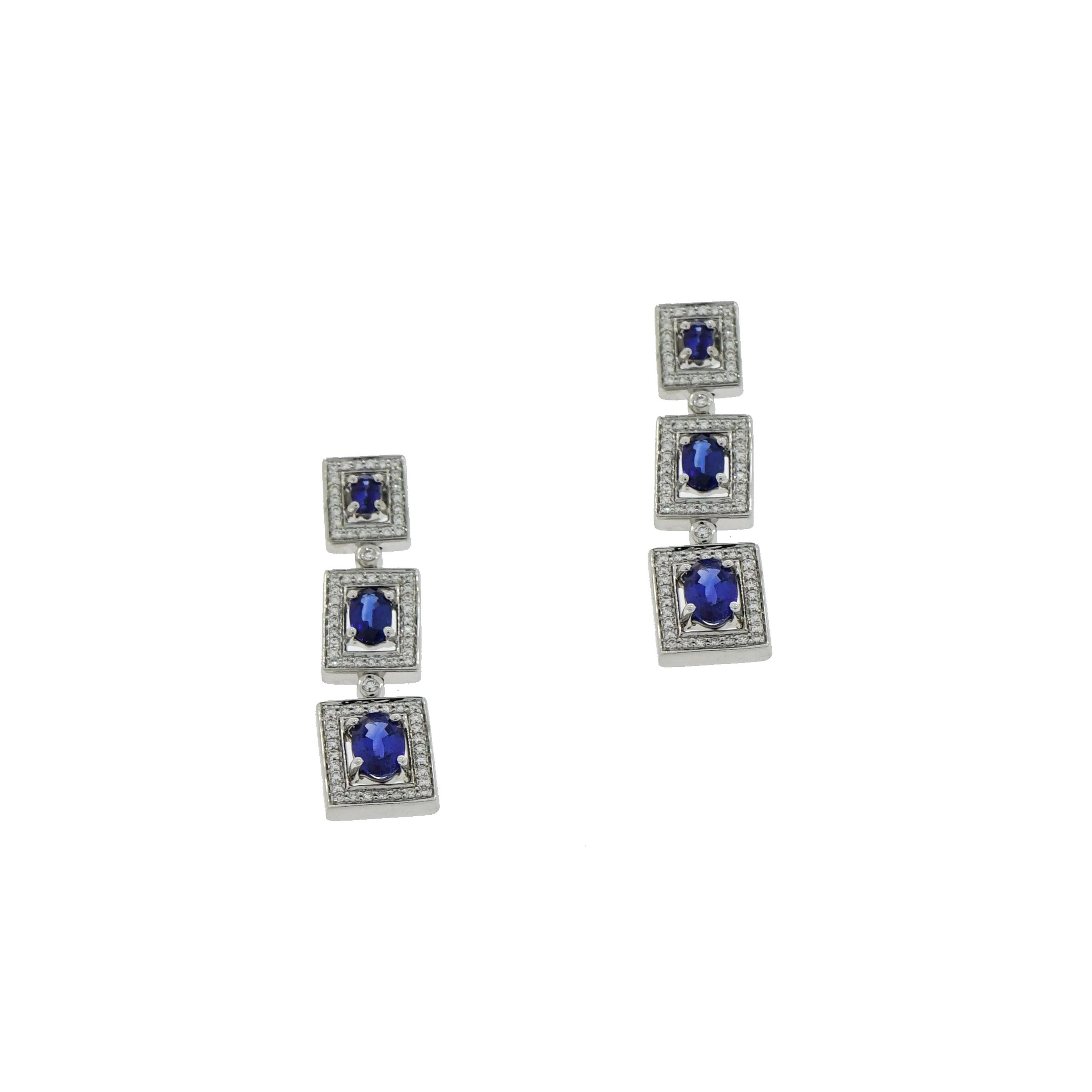 This gorgeous Graduated Oval Sapphire and Diamond Drop Earrings is crafted in 18K White Gold with 6 oval sapphires (7x5) 6x4 (5x3), weighing approximately 4.00 carat total and approximately 1.00 carat of round brilliant cut Diamonds.
