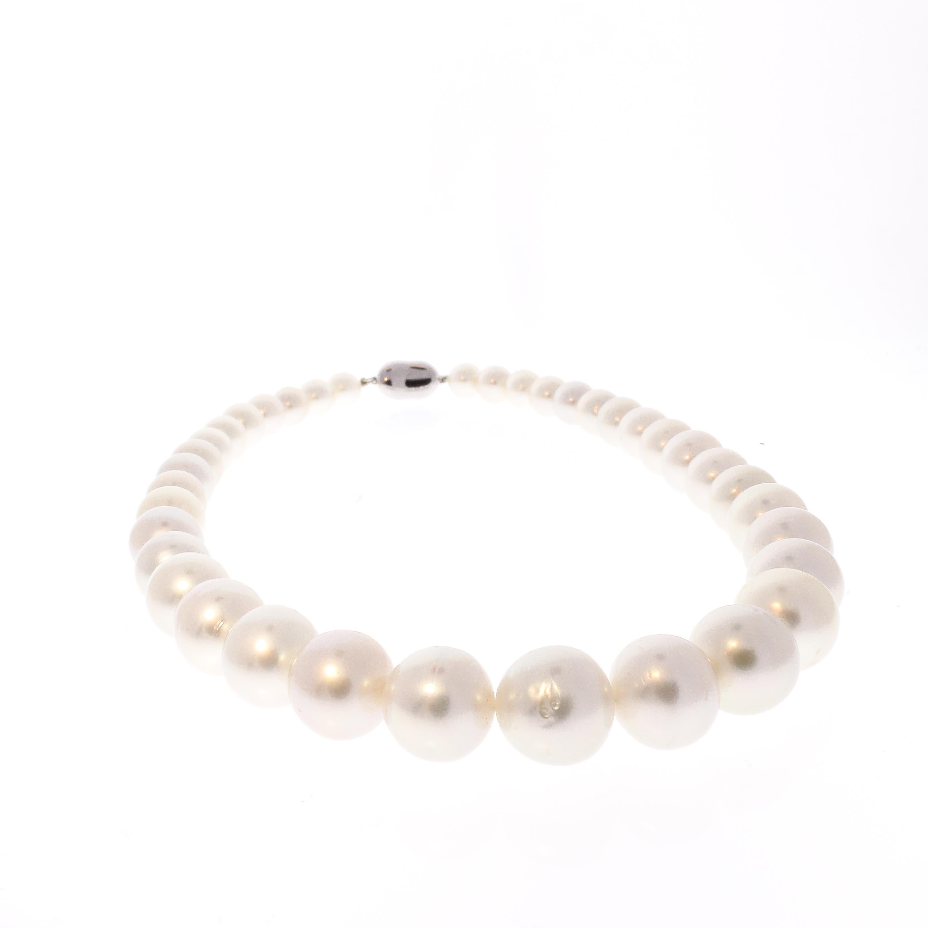 This exquisite pearl necklace features graduated South Sea white pearls that go from 8-13 millimeter.  The pearls have been selected for color matching and luster matching. The color of these pearls is ivory white. The timeless elegance of a fine