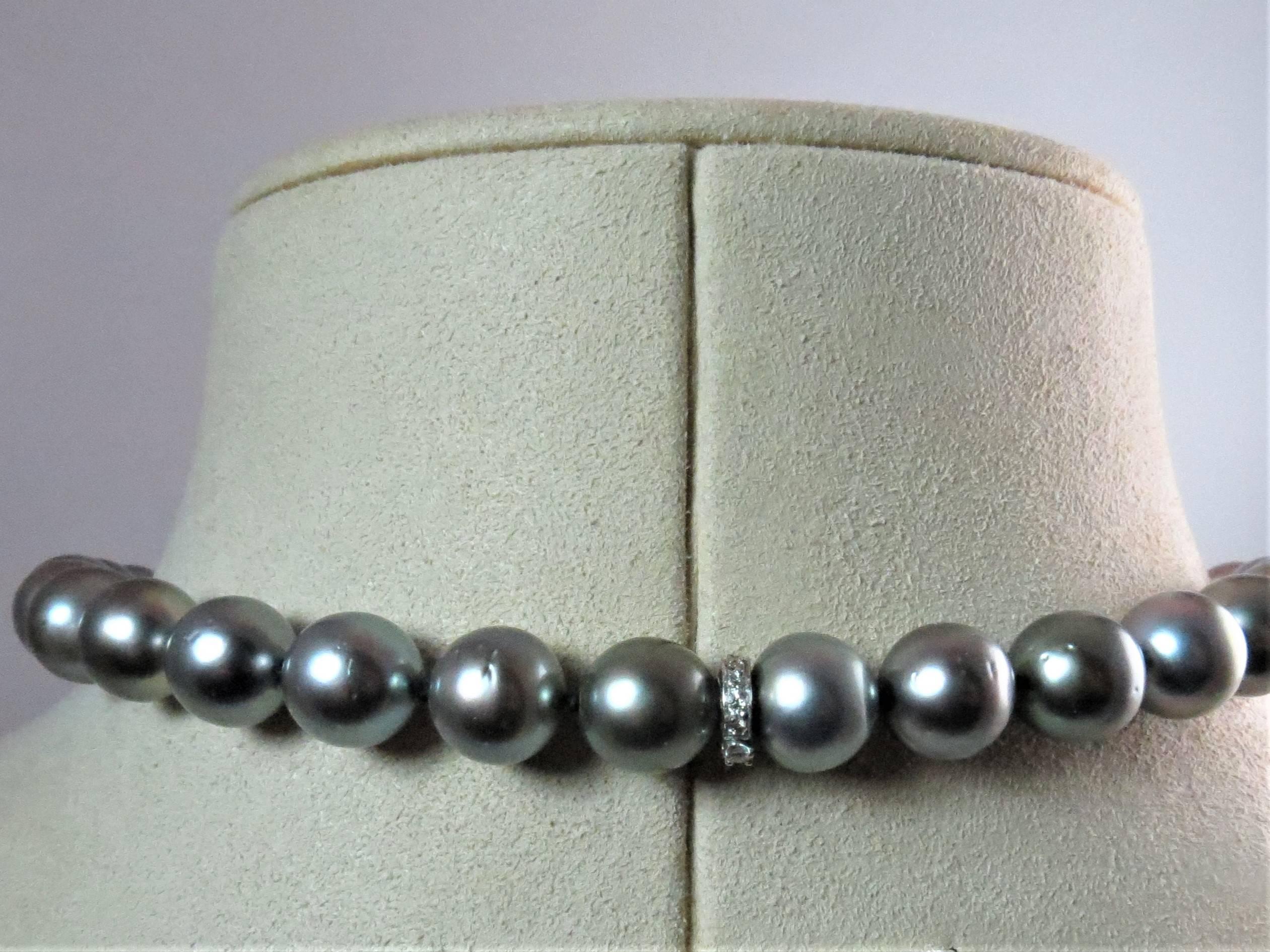 Graduated Tahitian black pearl necklace, with 37 black Tahitian pearls measuring 14.50mm to 10mm, 18 inches long, beautiful luster, with platinum diamond plunger clasp prong set with 13 full cut round diamonds weighing 0.15cts, H-I color, VS- SI1