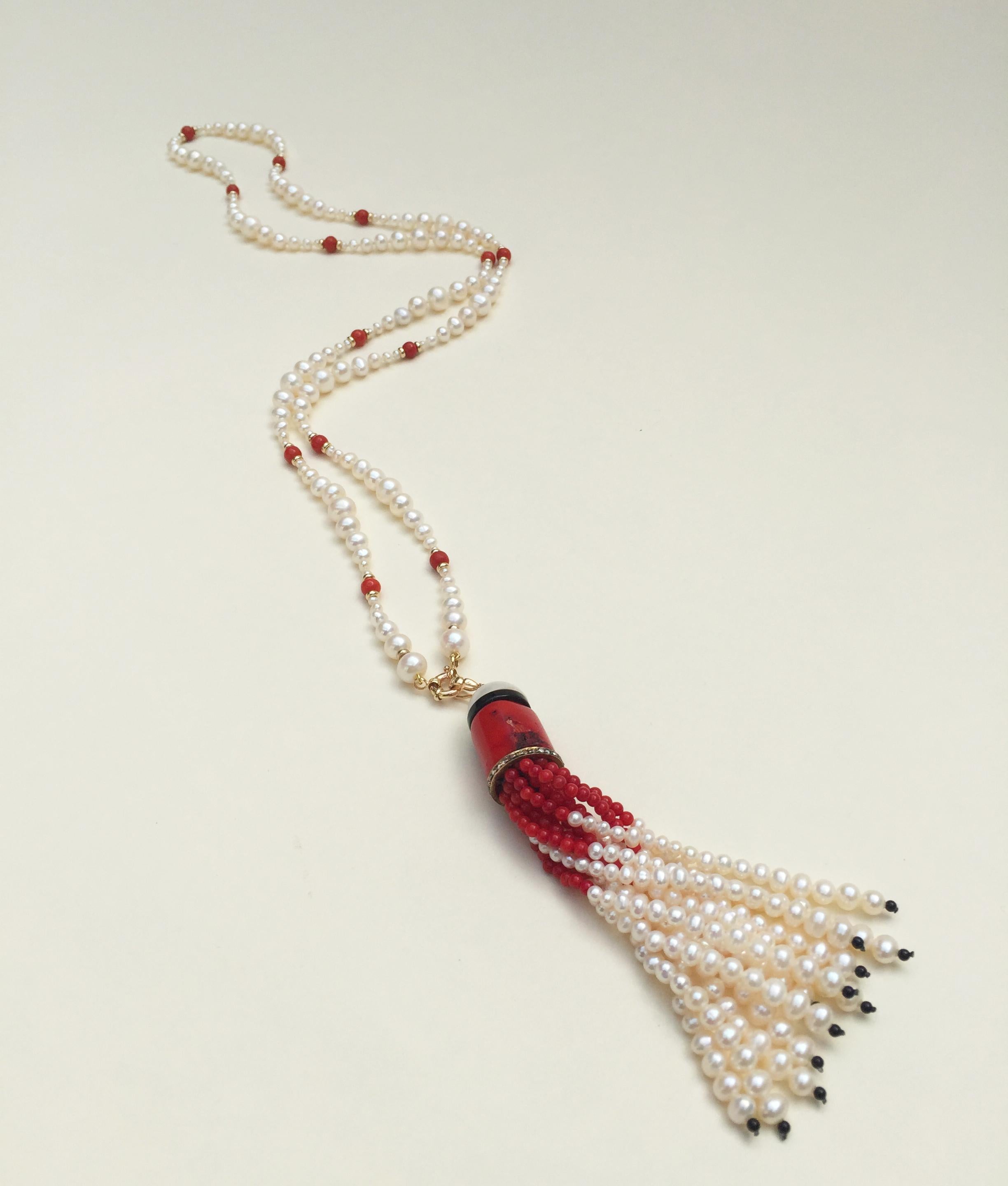 This graduated white pearl and coral necklace with tassel and 14k yellow gold clasp is beautiful with bright red coral and glowing white pearls. The necklace is handcrafted by Marina J. with her exclusive multiple graduated pearl design with round