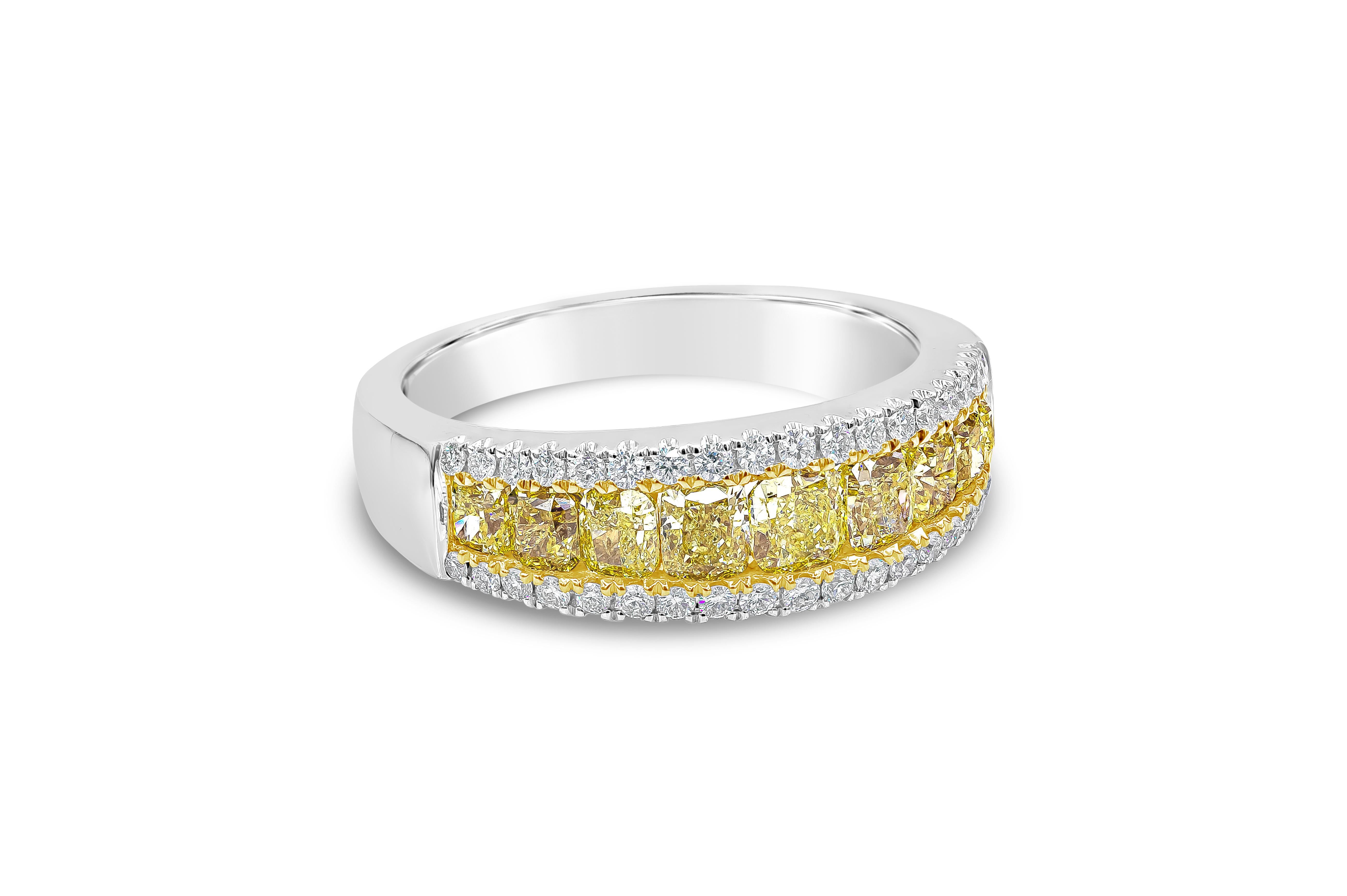 A dazzling wedding band showcasing a row of graduating color rich fancy yellow cushion cut diamonds weighing 1.60 carats total, flushed set in 18K yellow gold. Accented on each side is a row of brilliant round diamonds weighing 0.29 carats total.
