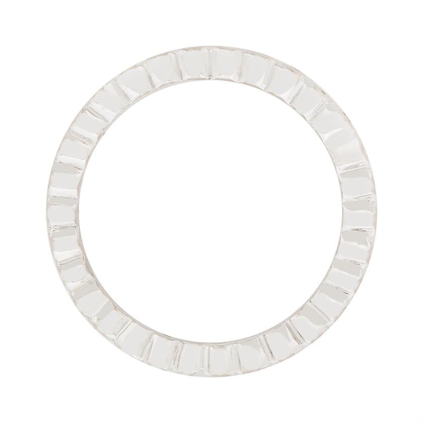 Thirty stunning diamonds wrap around the finger in this GRAFF eternity band. They are excellent quality, with grades of F in colour and VS in clarity. The diamonds total to 1.20 carat, and are held within platinum scalloped edge settings. The ring