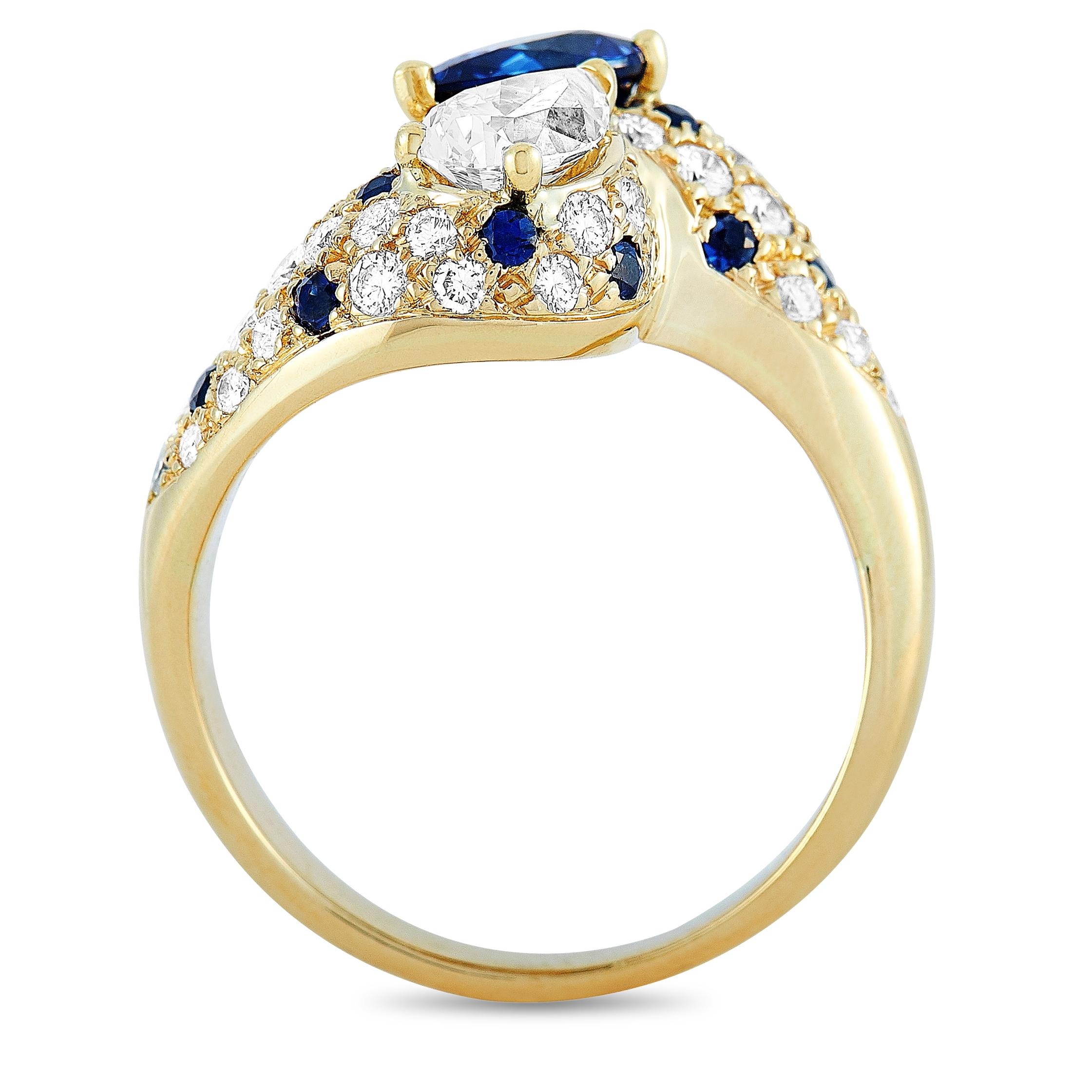 This Graff ring is made of 18K yellow gold and weighs 7.2 grams, boasting band thickness of 2 mm and top height of 6 mm, while top dimensions measure 20 by 13 mm. The ring is embellished with diamonds and sapphires that total 1.40 and 1.28 carats