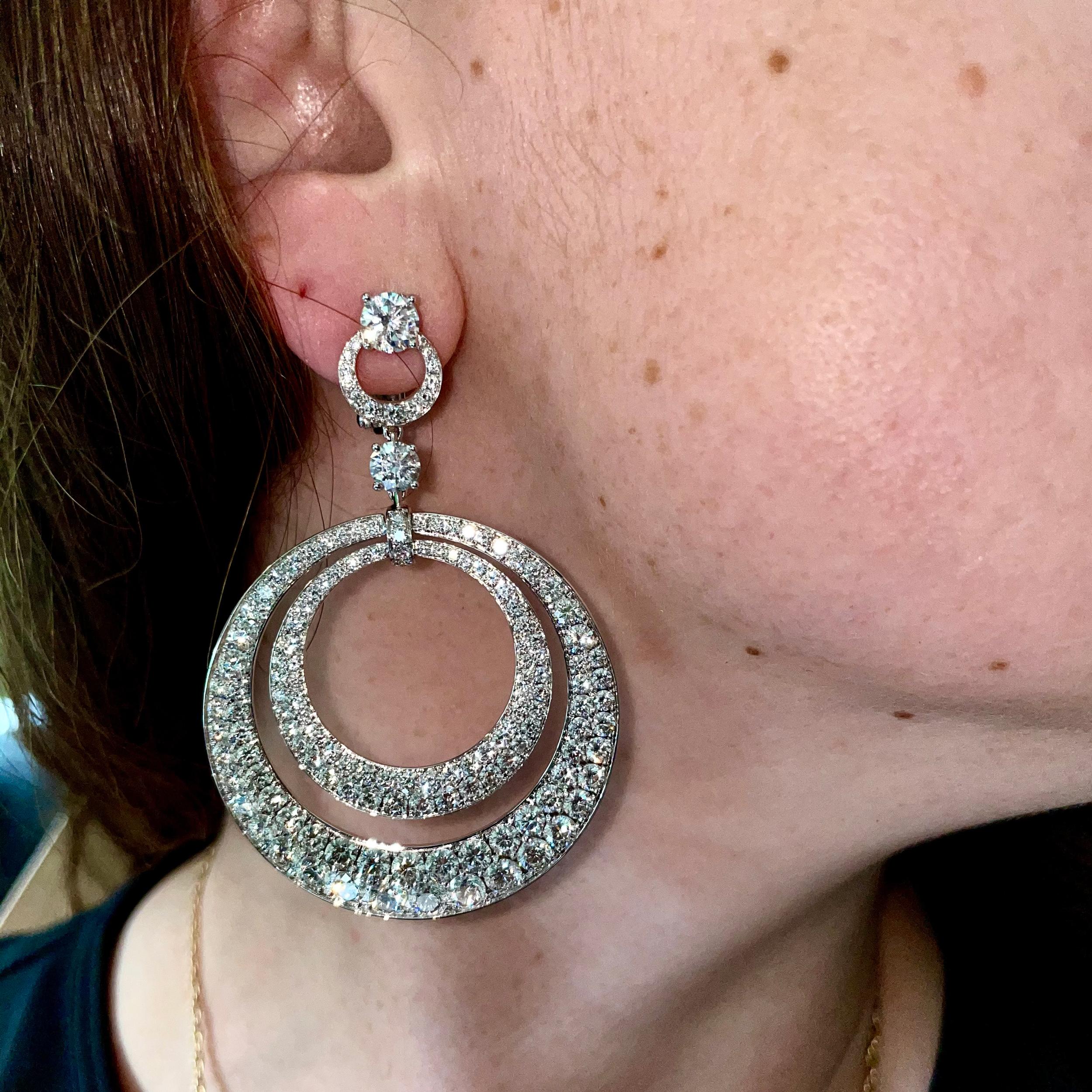 An incredible set Graff diamond earrings showcasing a double hoop design set with brilliant-cut diamonds totalling 17,80cts appx. The earrings have a post and hinge back fittings for safety. The earrings are signed Graff, numbered, and include pouch