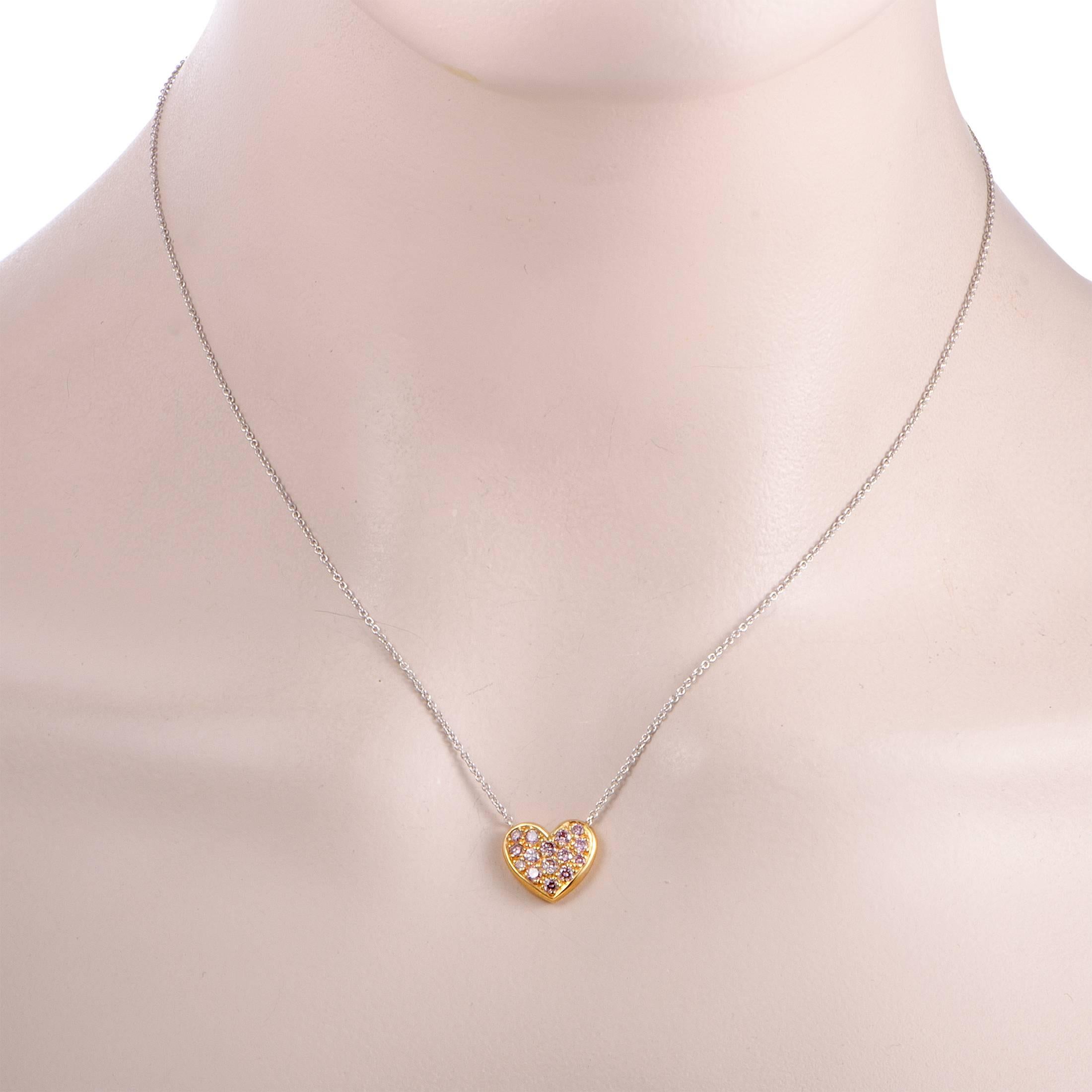 This gorgeous necklace is a Graff design that is presented with an 18K white gold chain onto which a dainty heart pendant is attached. The pendant is crafted from 18K yellow gold and beautifully set with lovely pink diamond stones that amount to