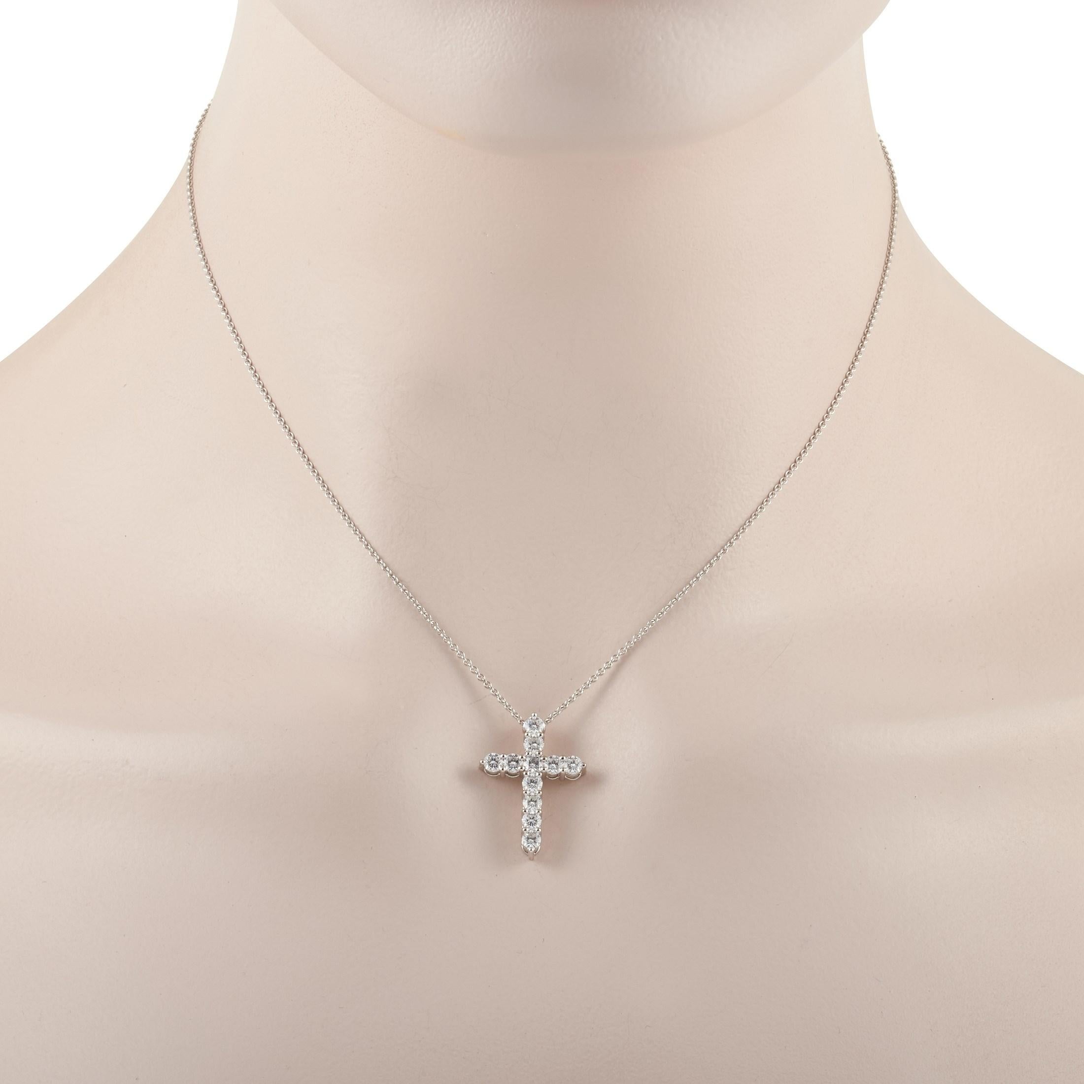 This pretty Graff 18K White Gold 1.10 ct Diamond Cross Necklace is made crafted of 18K white gold, and features a cross pendant on a chain set with diamonds that weigh 1.10 carats of E color and VVS Clarity. The dainty chain measures 15 inches in