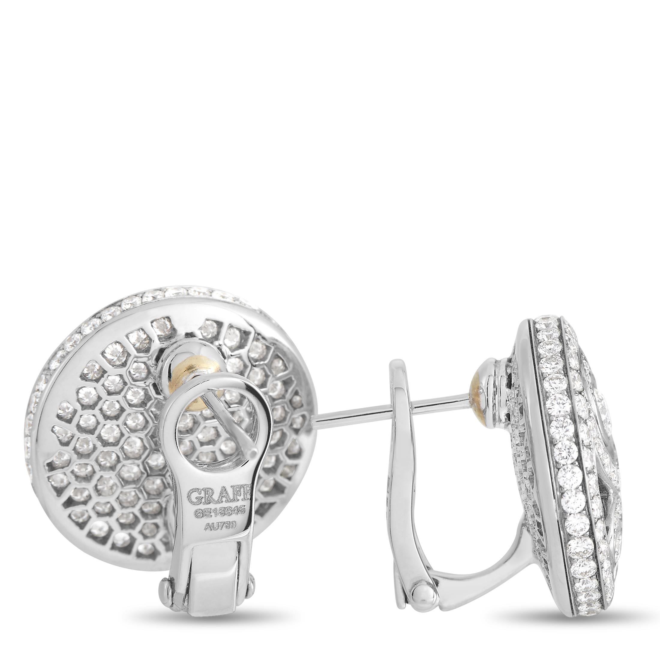 Stylish swirls and a shimmering 18K White Gold setting come together to create a pair of earrings that are nothing short of spectacular. Together, they feature a striking 5.29 carats of diamonds with E color and VVS clarity. Each one measures 0.75”
