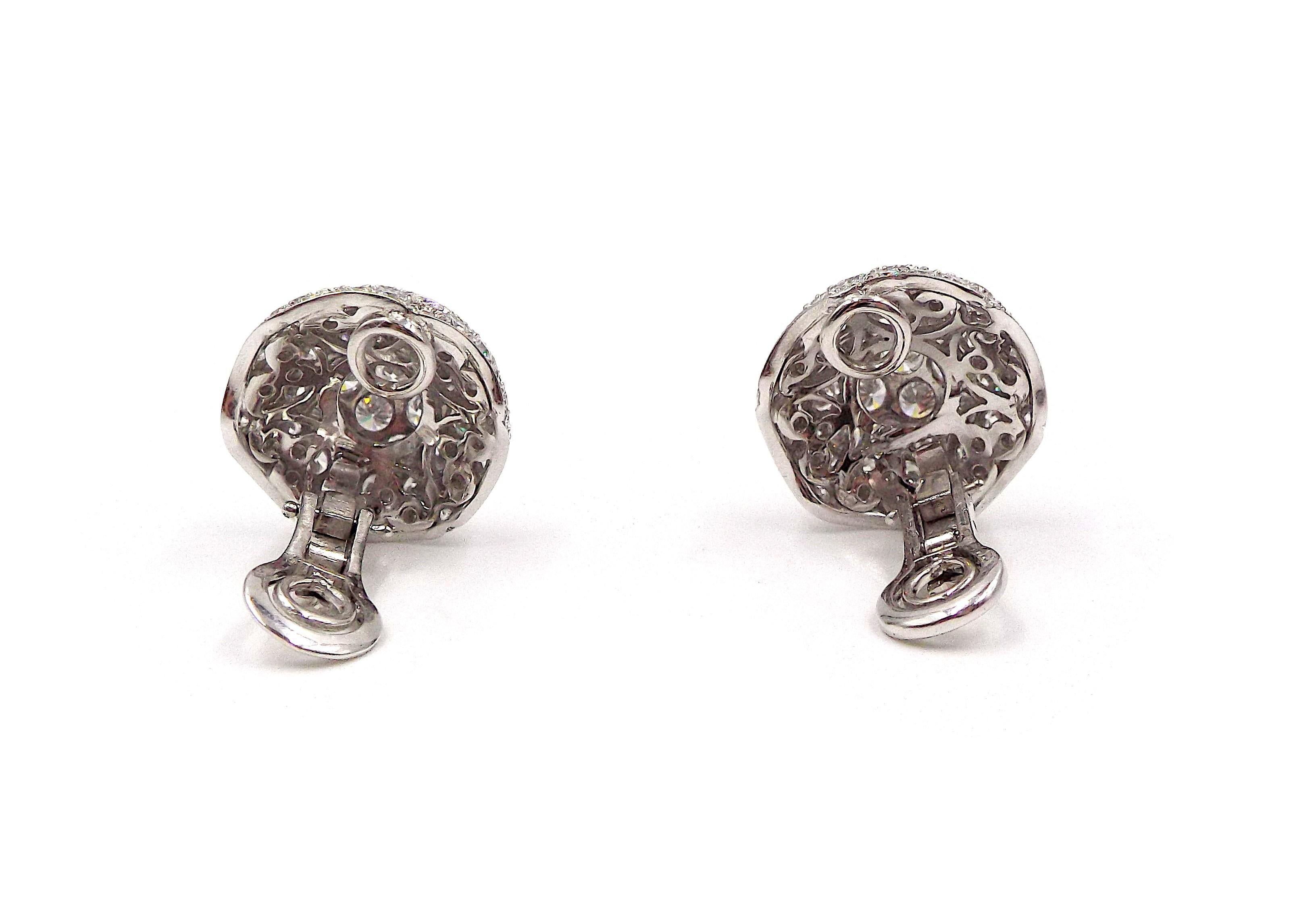 A pair of fancy white gold and diamond dome-shaped earrings by Graff. Weight is 15.5g, diamond weight is approximately 12ct. Earrings are approximately 2cm in diameter.