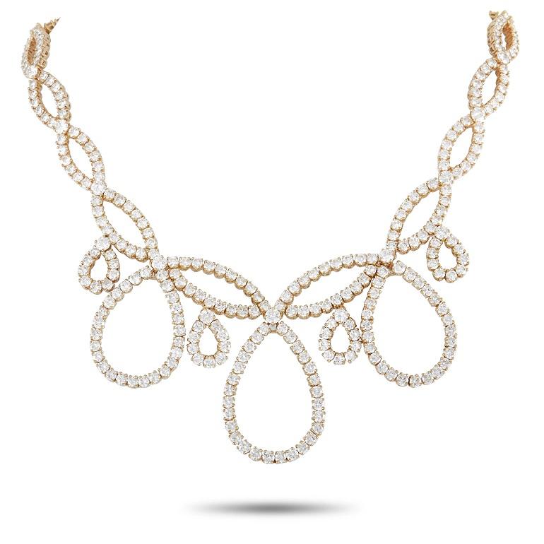 This necklace and earring set from Graff exudes classic elegance and refinement. On the 15” long necklace, a swirling 18K yellow gold setting plays host to a breathtaking array of diamonds with a total weight of 30.6 carats, F color, and VVS