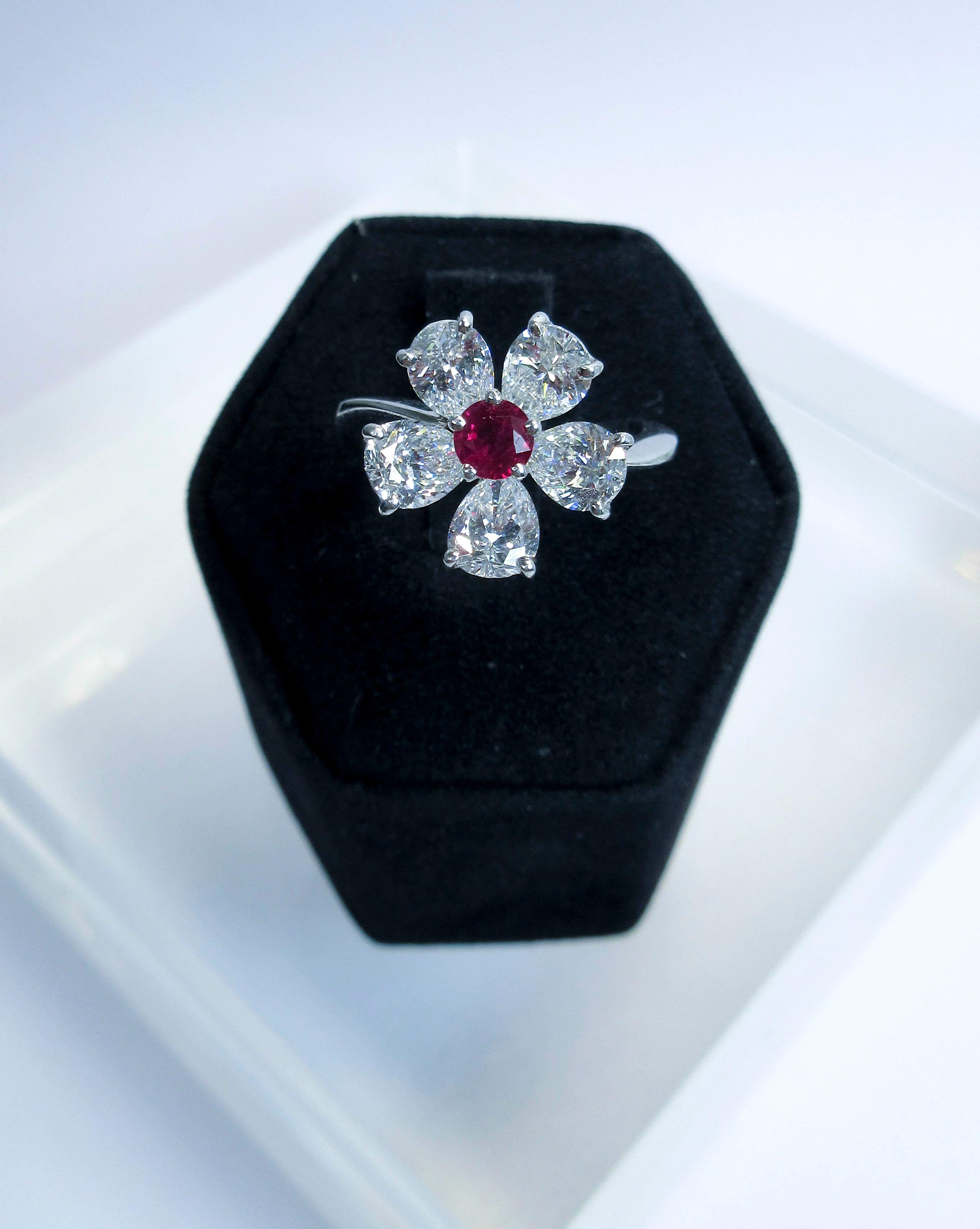 RARE
Graff, 18kt white gold, with 5 pear shape diamonds.
Diamonds 2.60cts.
Color E
Clarity VVS and VVS1
Natural untreated Ruby center stone 0.28cts.  