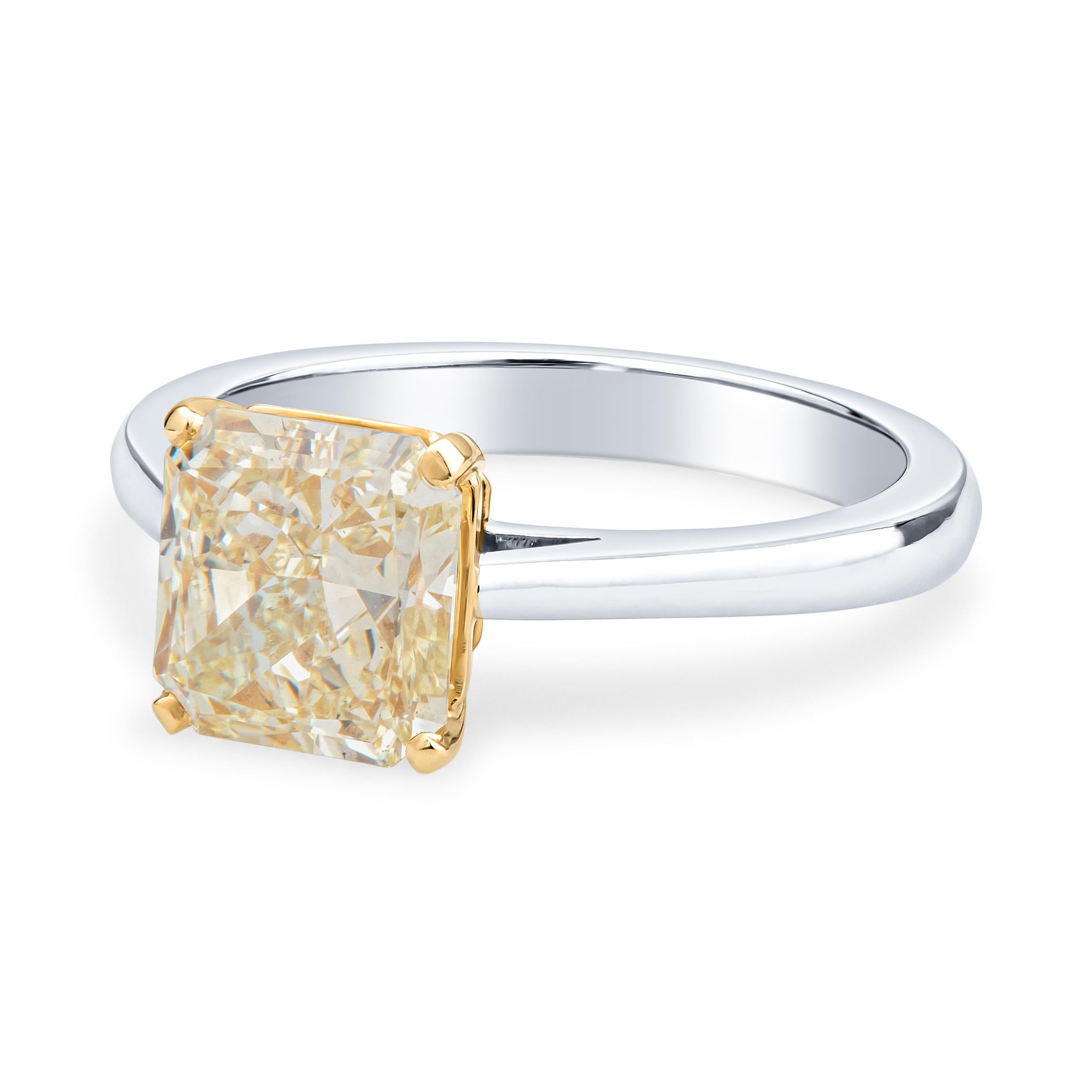 This dainty, beautiful engagement ring from the world famous Graff jewelry house features a 2.16ct radiant cut, fancy light yellow diamond, VS2 clarity, set in an 18kt yellow gold setting to complement the yellow hue of the diamond. The band is